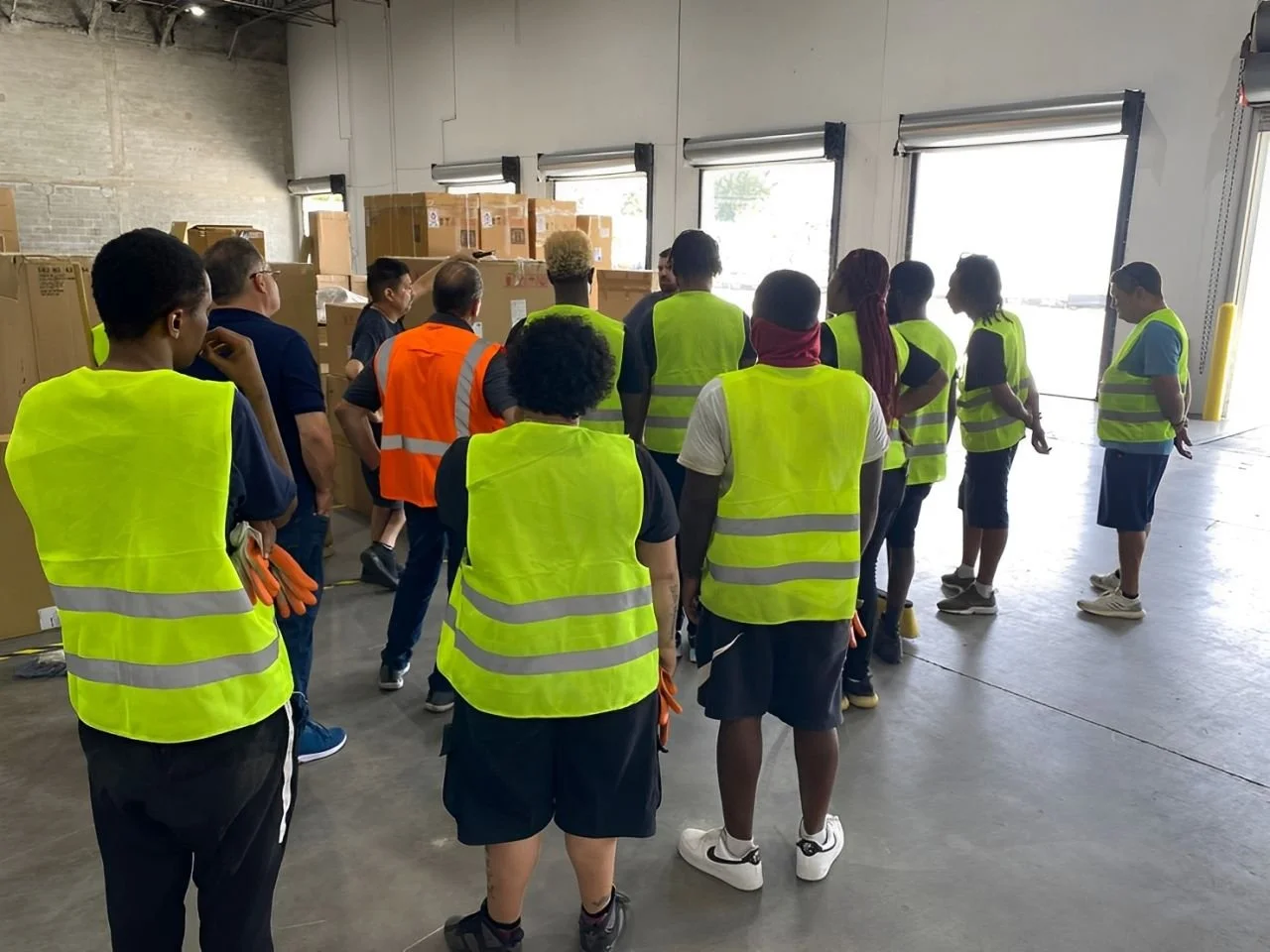 DNA Logistix leadership team conducting a warehouse safety briefing and operations training session at a national distribution facility, demonstrating our commitment to safety, compliance, and workforce development.
