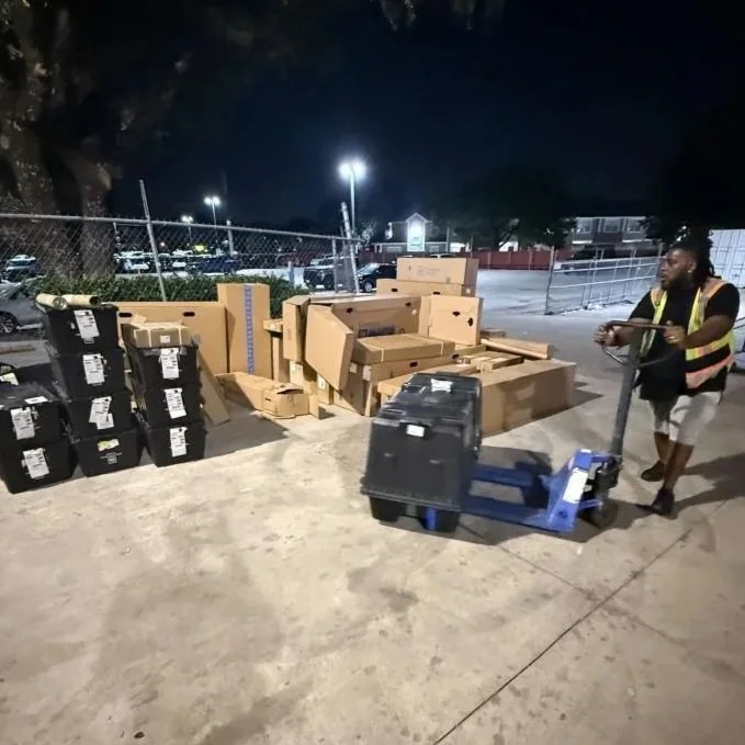 DNA Logistix warehouse associate operating a pallet jack during evening shift logistics operations, illustrating our 24/7 warehousing, distribution, and dedicated transportation services across the United States.