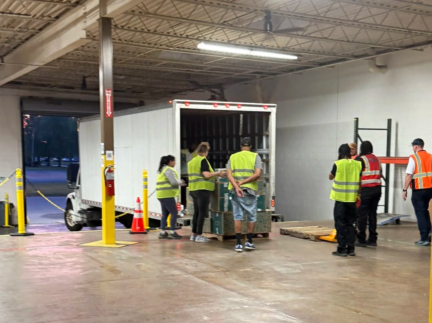 DNA Logistix warehouse team loading freight at a national distribution center, supporting B2B transportation, dedicated fleet operations, and last-mile delivery services across the United States.