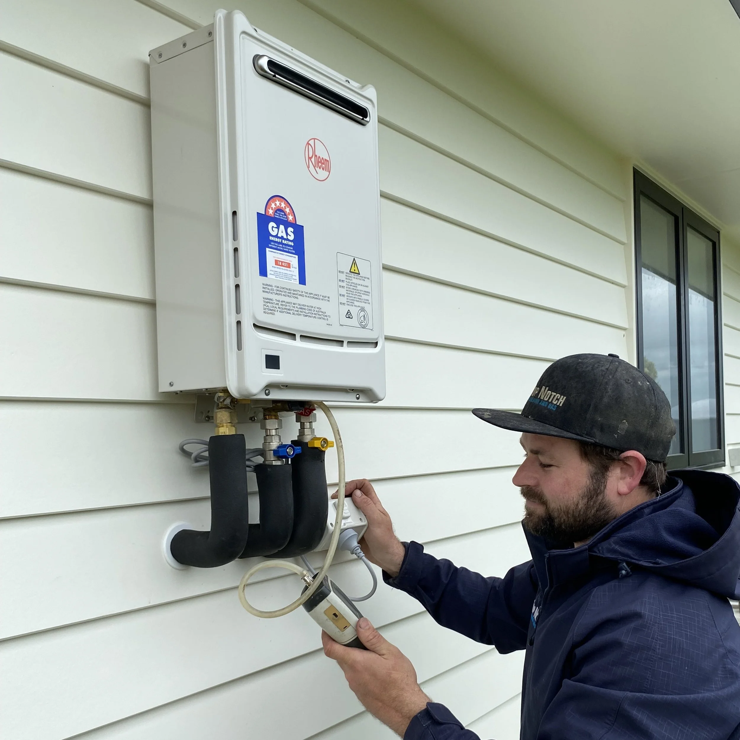 Gasfitter testing new gas hot water system upon installation