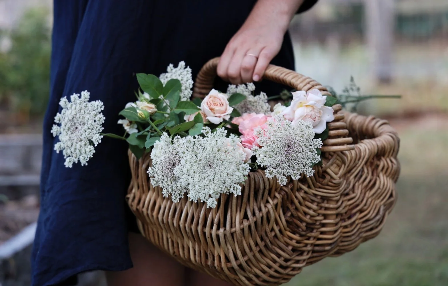 A basket full of homegrown cut flowers from a cottage garden to be sold locally at a roadside farmstand