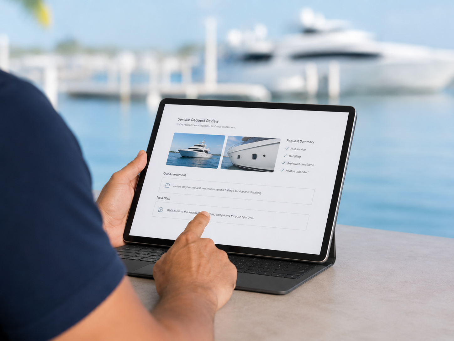 Person using a tablet to review a service request for a yacht, with a marina and yachts in the background.