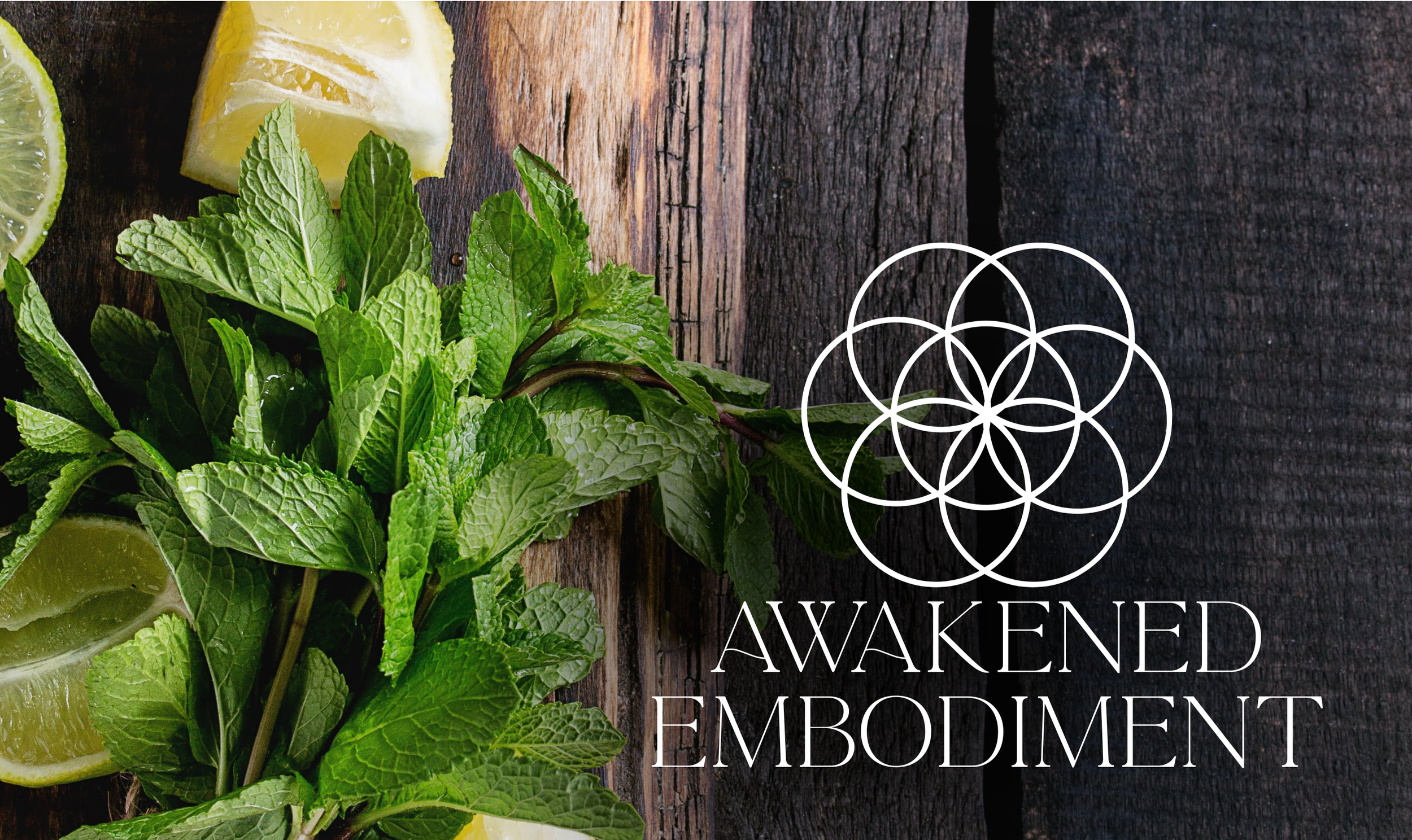 Lemon and lime slices with fresh mint leaves on a rustic wooden surface, with the words 'Awaken Embodiment' overlaid