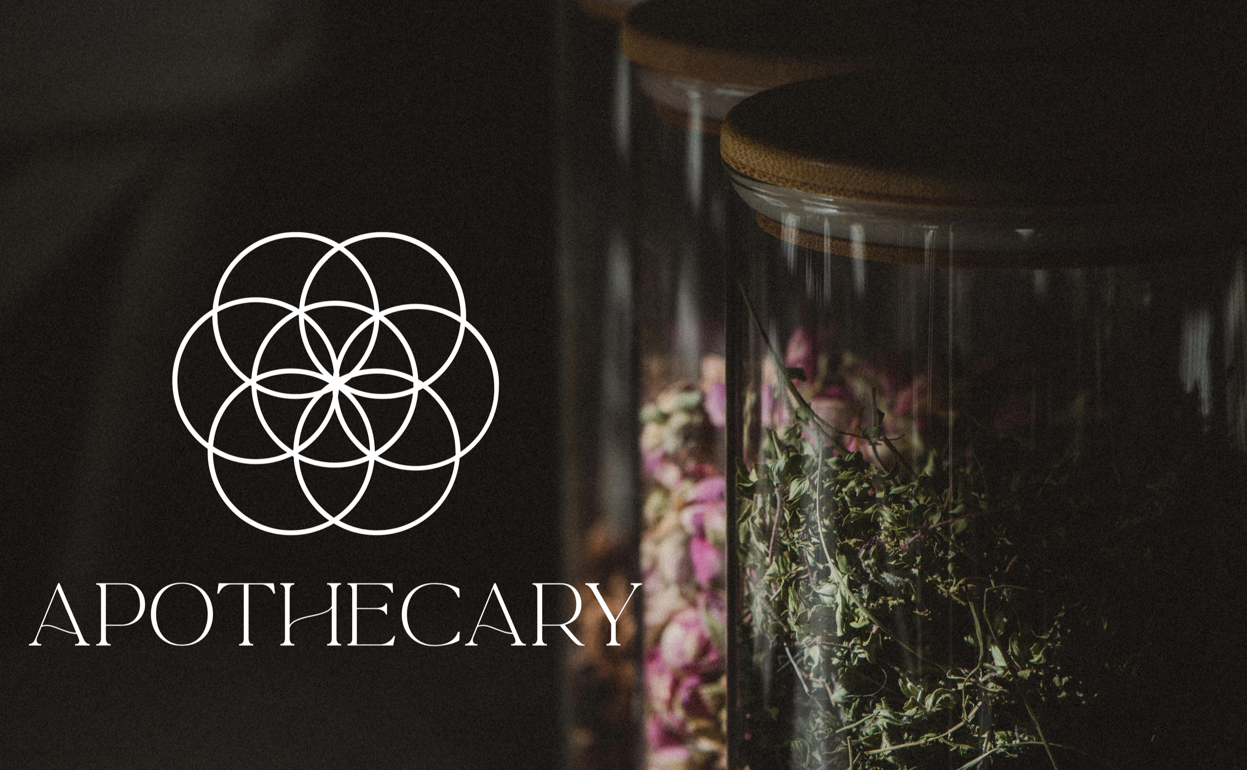 Close-up of glass jars filled with dried herbs or flowers on a dark surface, with a soft focus background.