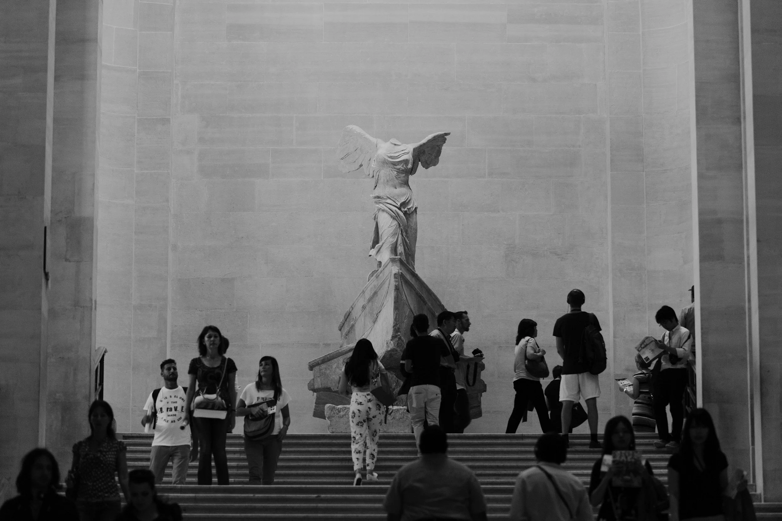 People walking up and down stairs in front of the Statue of Freedom at the top of the Capitol building, Washington D.C.