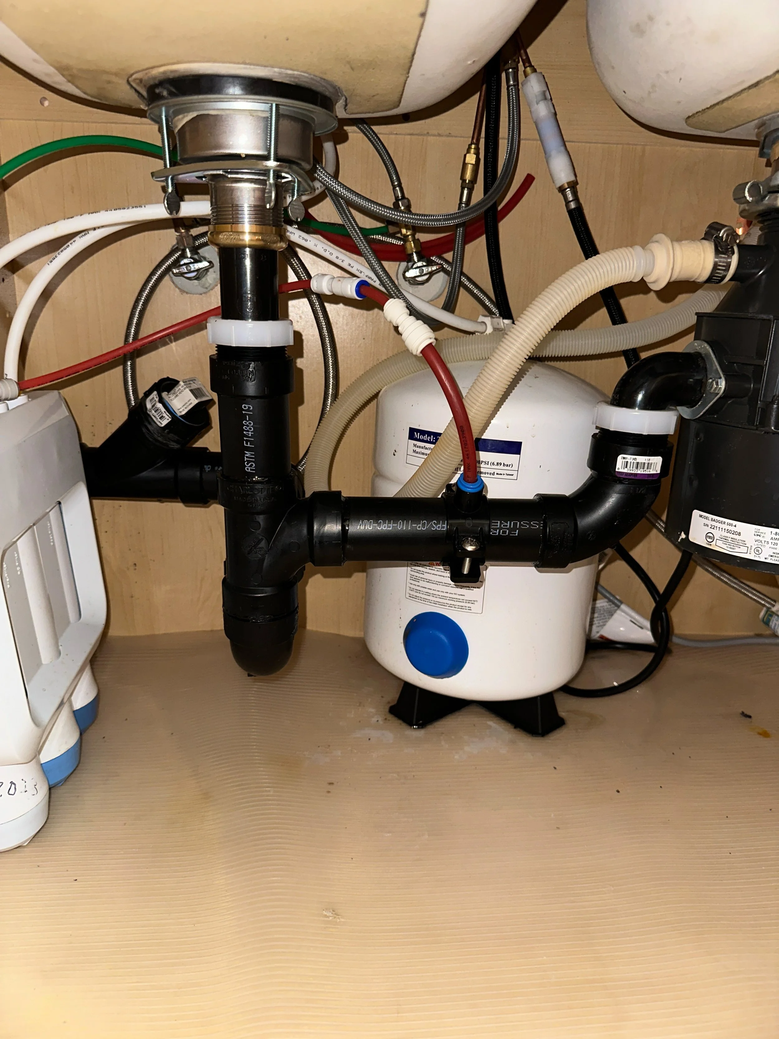 Basket strainer and under sink piping with clean out in ABS installed in Pasadena, CA.