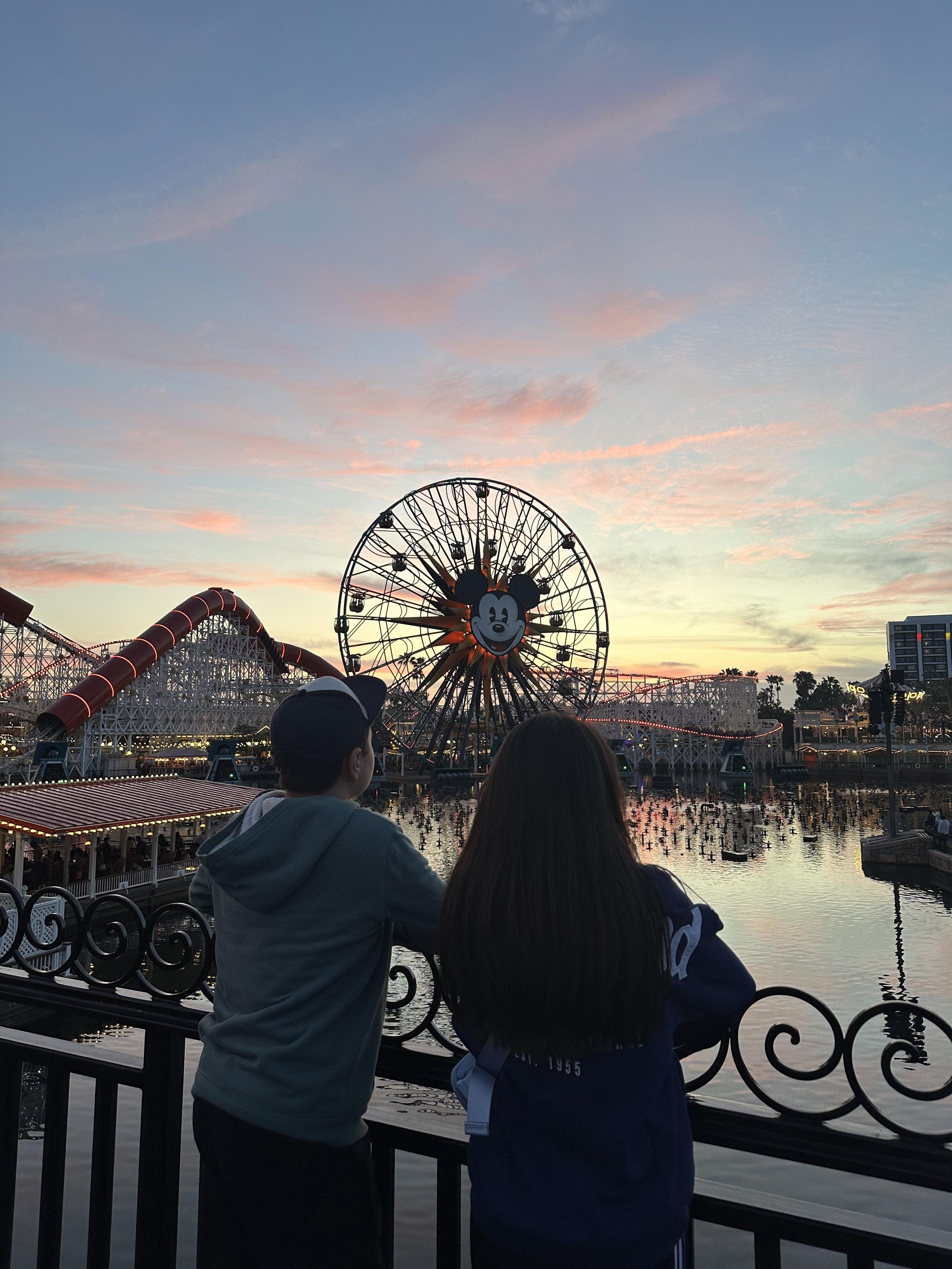 My two kids walking on Pixar Pier during golden hour at Disney California Adventure, taking in the Disneyland magic.
pixar pier, disneyland memories, golden hour, kids at disney