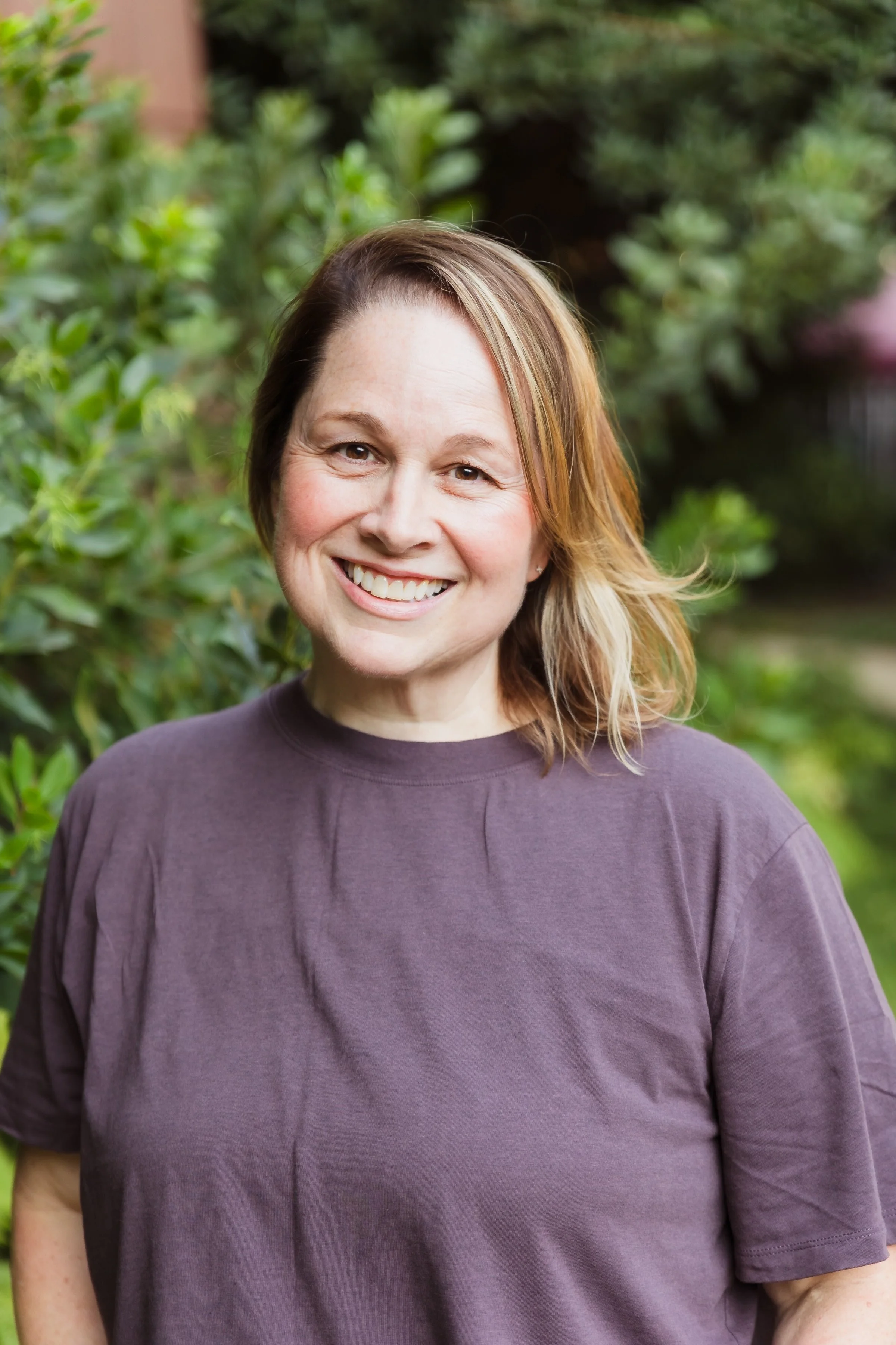genX-woman-fair-skin-blonde-and-brown-hair-wearing-a-purple-shirt