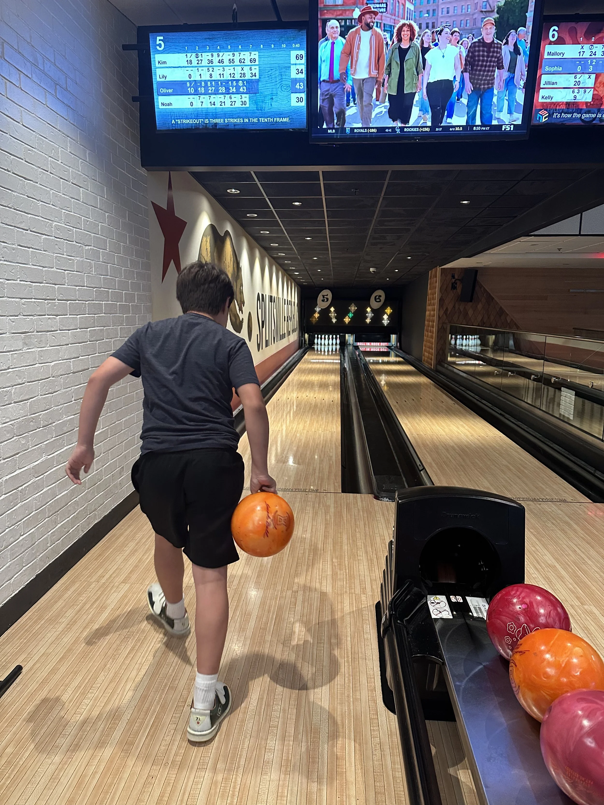 my-son-bowling-with-an-orange-bowling-ball-at-splitsville-in-downtown-disneyland