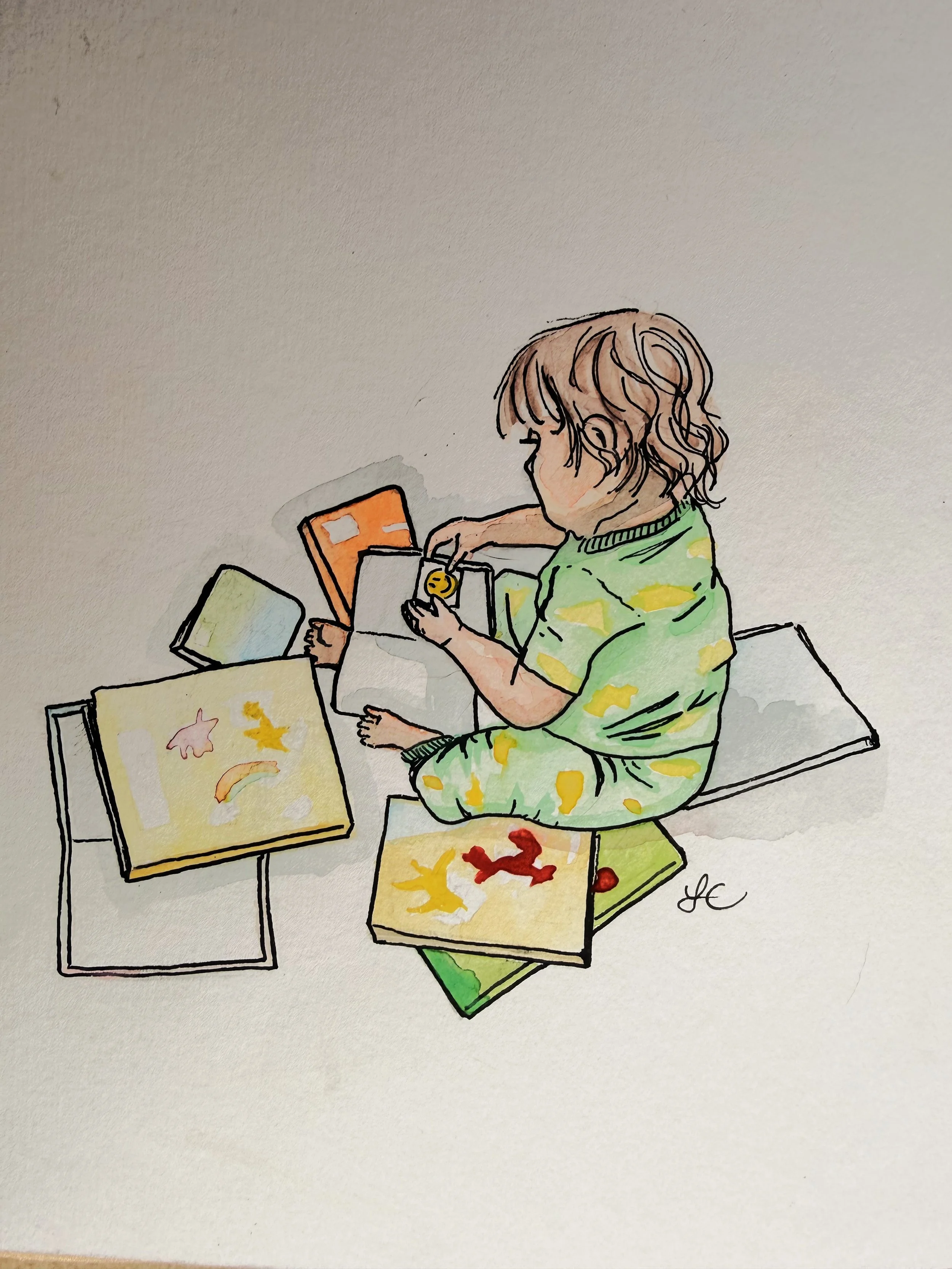 A colorful illustration of a child with brown, curly hair sitting on a green cushion, engaging with various papers and cards on a small table, with a plain light background.