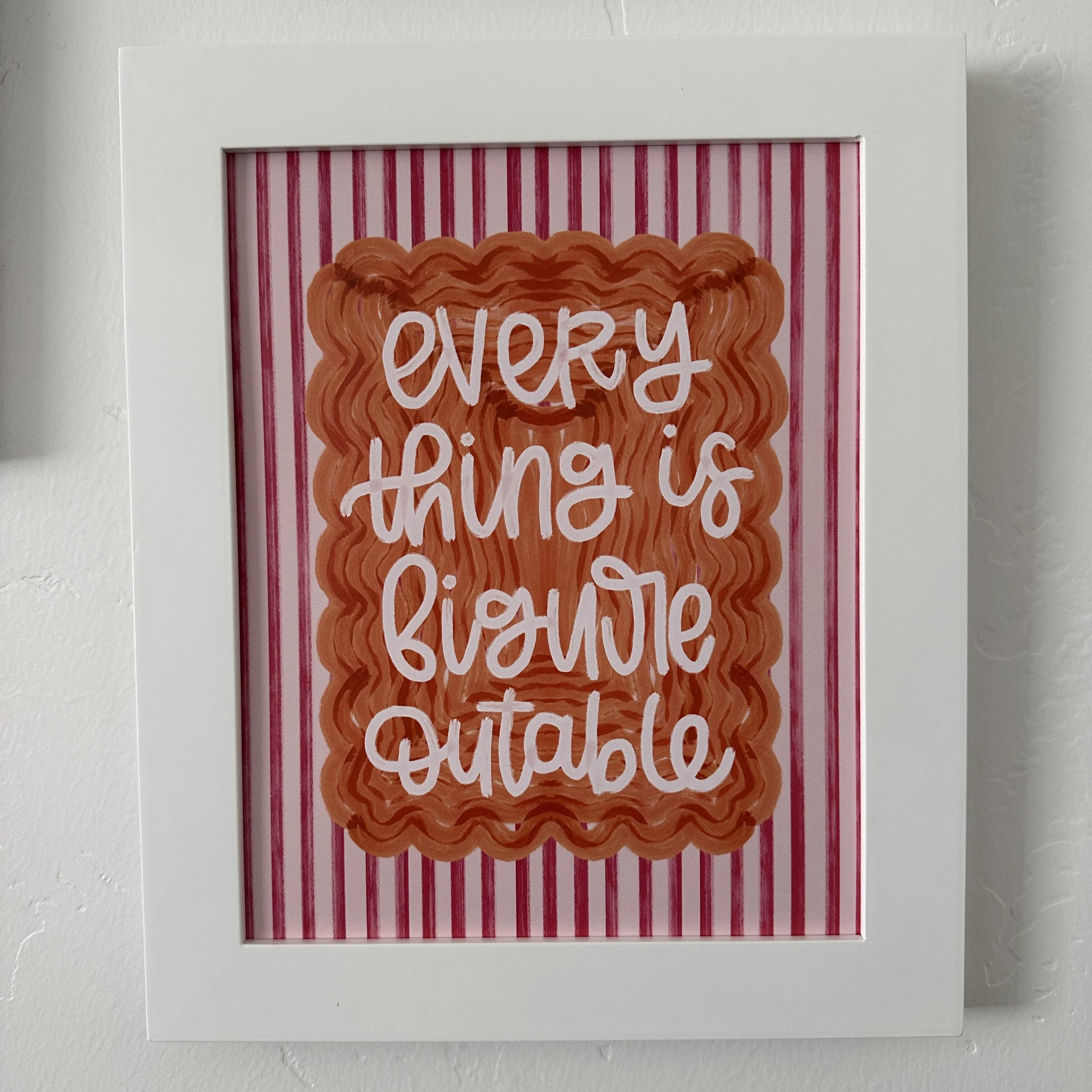 Festive card with red and pink vertical stripes, featuring a wreath-shaped decoration and the message 'Every thing's a little better' in white cursive text.