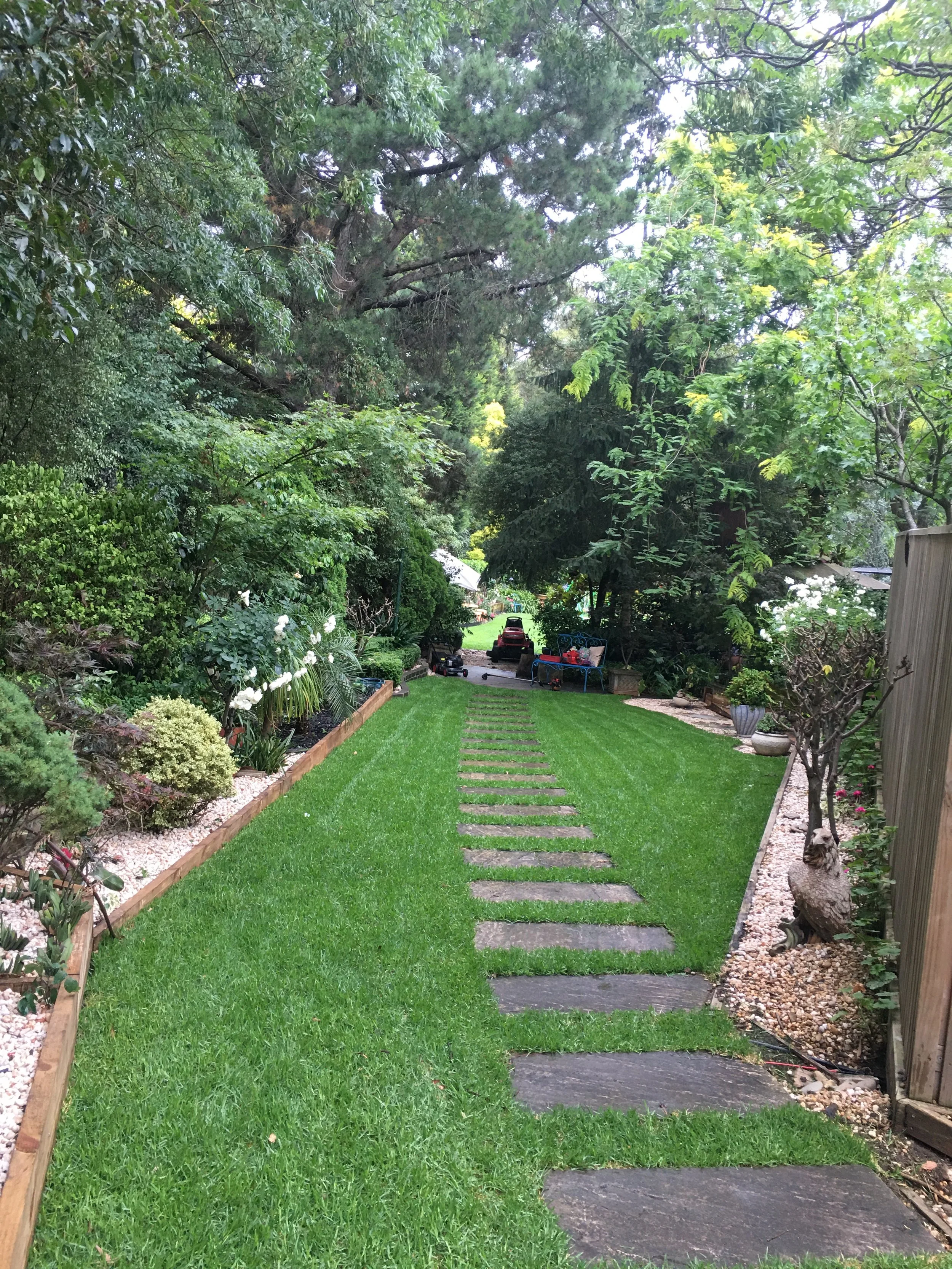 Landscaping By Mario — completed garden makeover featuring stone pathway, lush garden beds and established planting. Professional landscaping services across Melbourne's eastern suburbs including Whitehorse, Manningham and Monash.