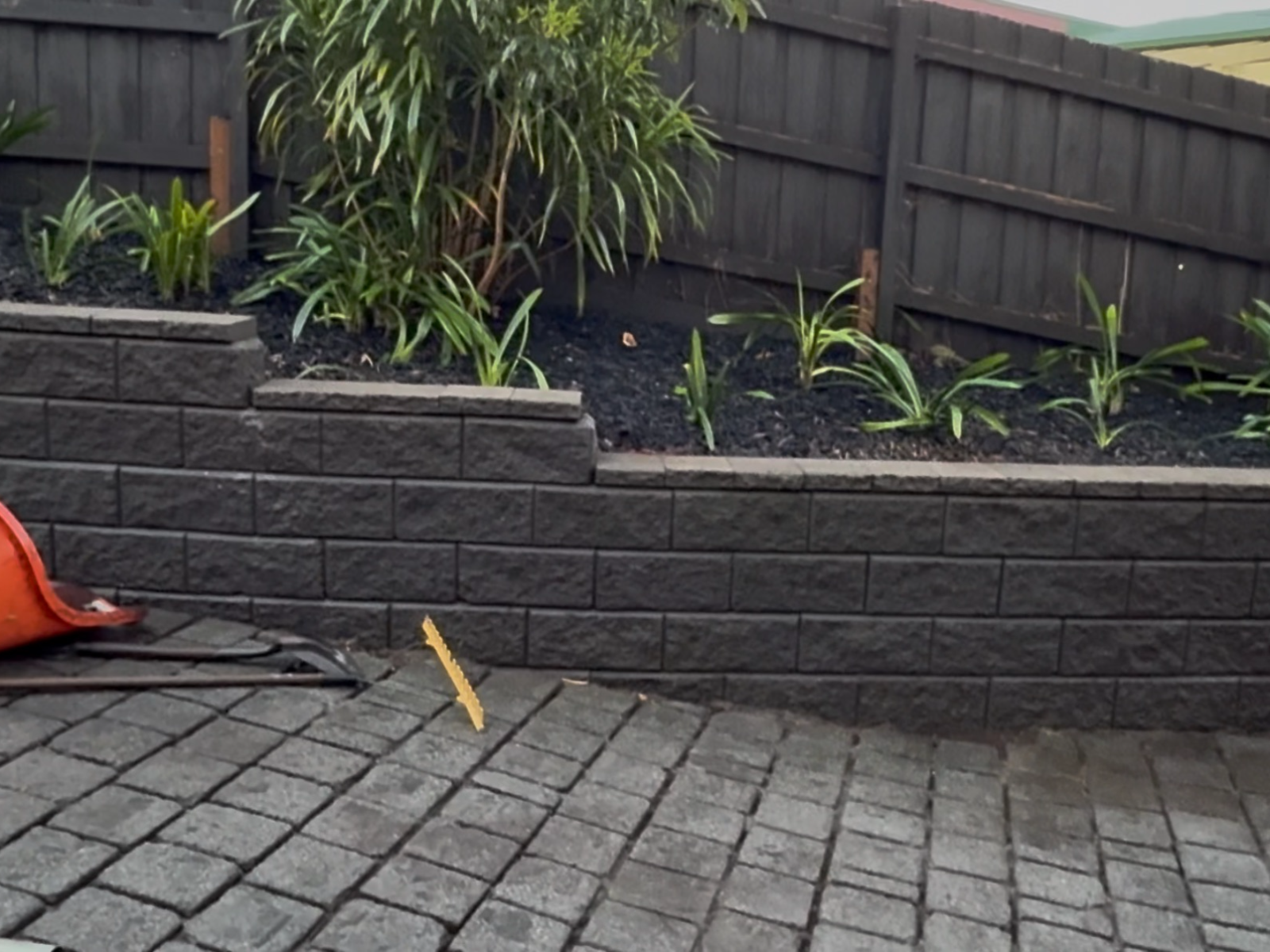 Pressure-washed driveway pavers and freshly mulched garden bed after a Vermont South clean-up