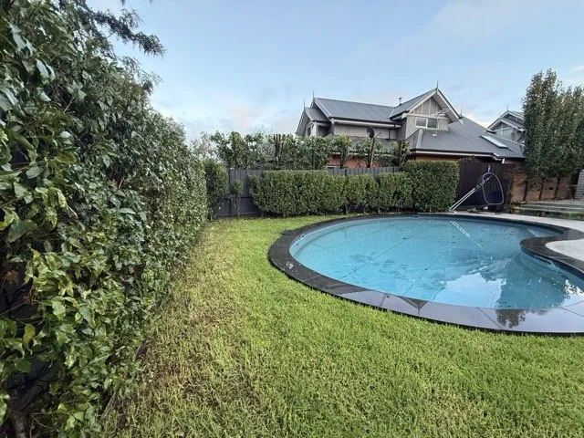 Straight clipped hedges around a pool, Blackburn backyard