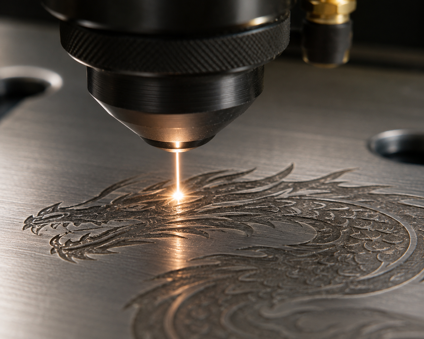 A laser cutting machine engraving a detailed dragon design onto a metallic surface.
