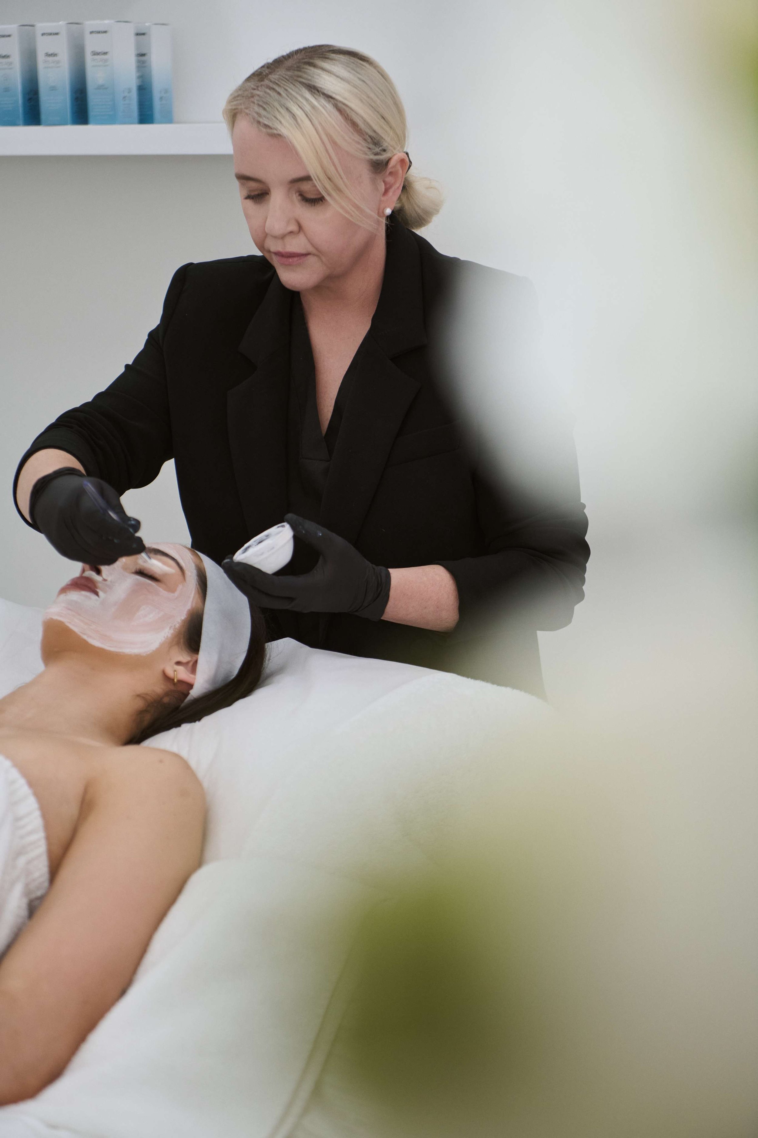 A woman receiving a facial treatment at Skin Room Perth, with Amy Middleton | Senior Dermal Therapist applying a facial product.