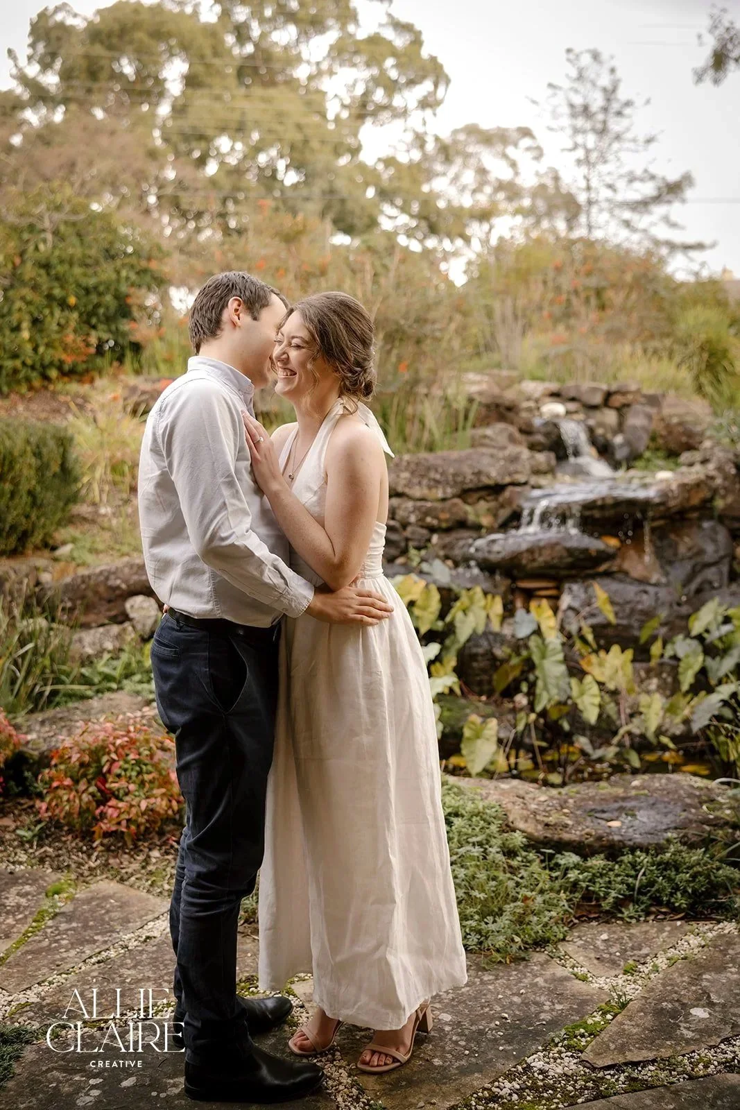 couple phtoshoot by Allie Claire Photography in front of the Waterfall on a cool day