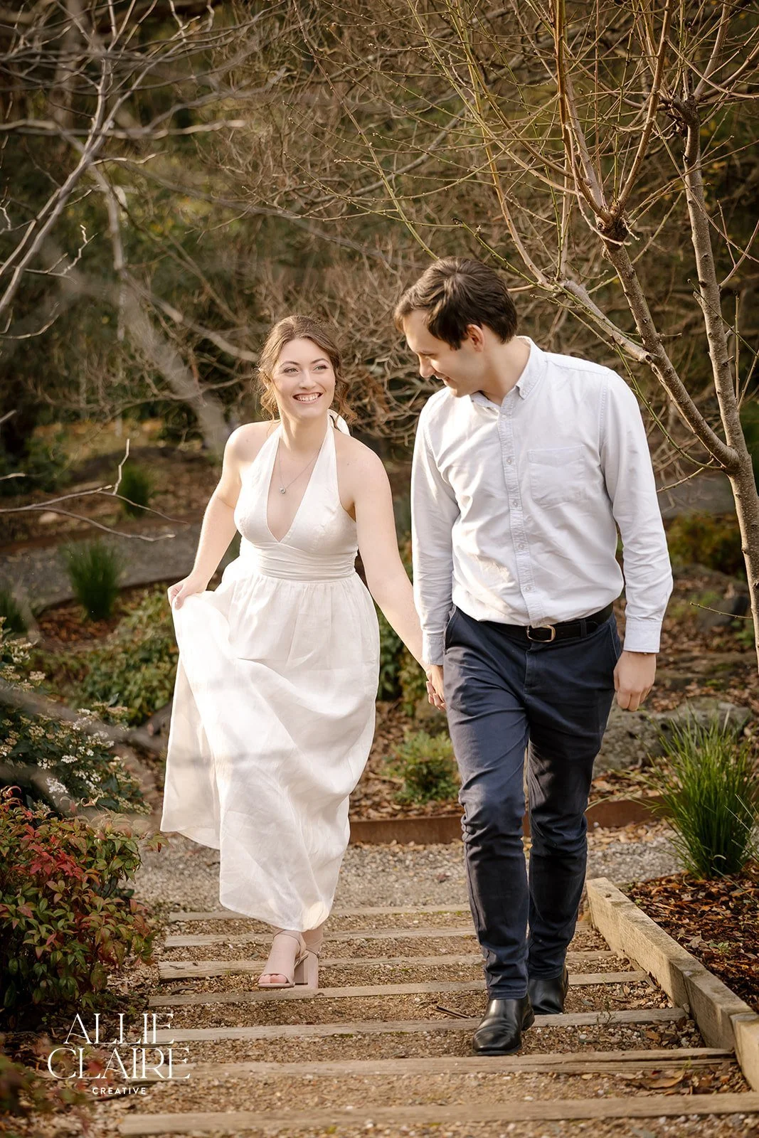 couple walking up the crushed rock path at The Elopement House in Winter by Allie Claire Photography