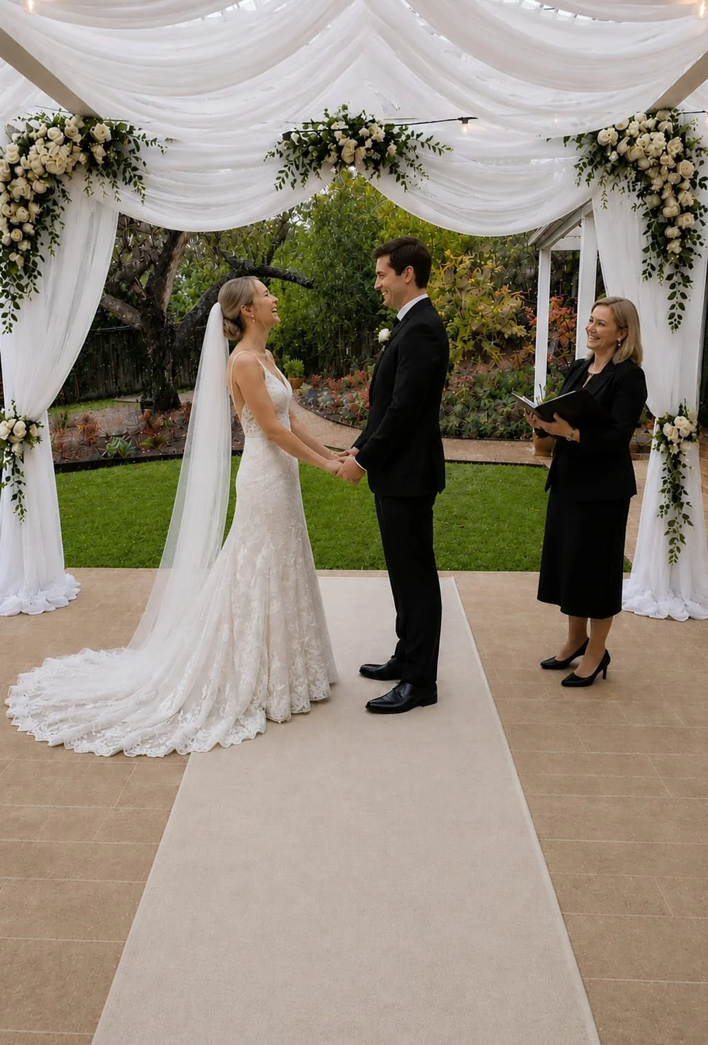 getting married under the canopy of drapery and flowers in front of the garden walk
