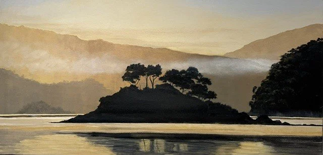 A serene landscape of a river with an island that has trees, surrounded by misty mountains in the background during sunrise or sunset.