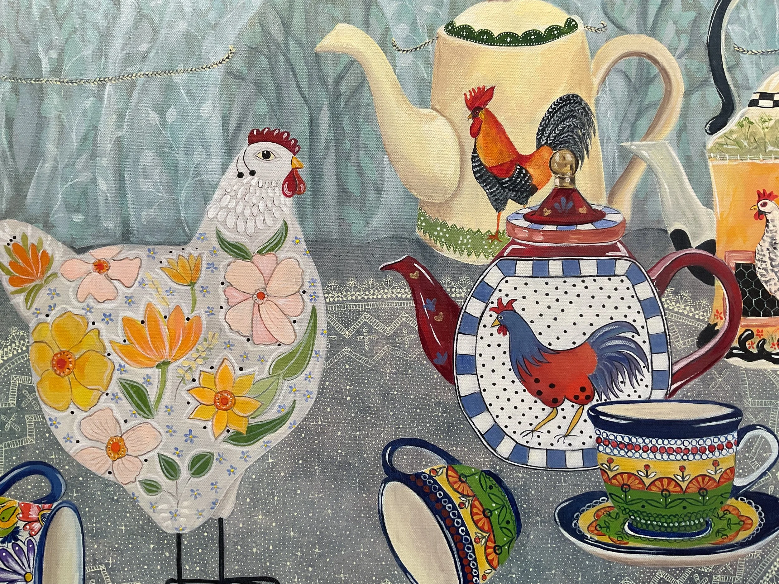 Decorative tablecloth featuring flowers, chickens, roosters, teapots, cups, and plates with colorful patterns, set on a table with a blue background.