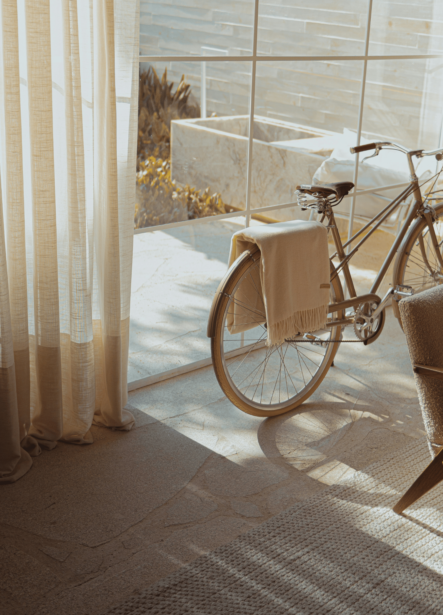 Minimal sunlit interior with a vintage bicycle and soft linen textures, inspired by slow living and simple everyday moments.