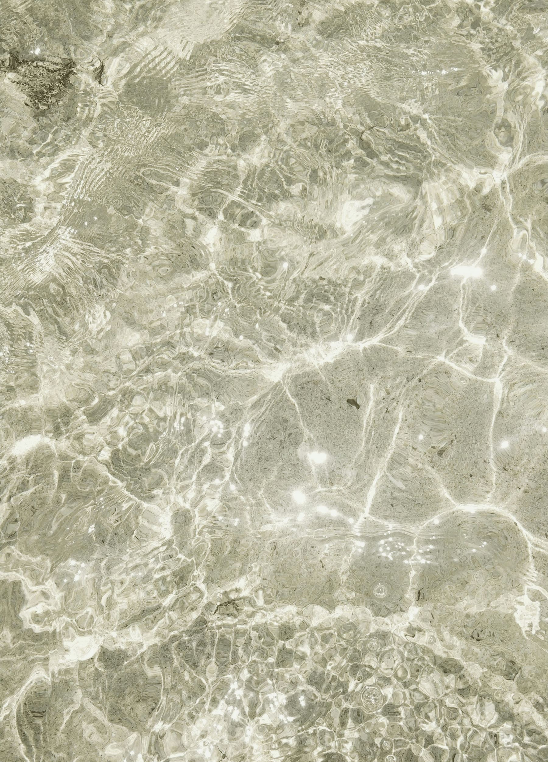 Clear sunlight reflecting across calm shallow water, symbolising clarity, mindfulness, and gentle wellbeing.