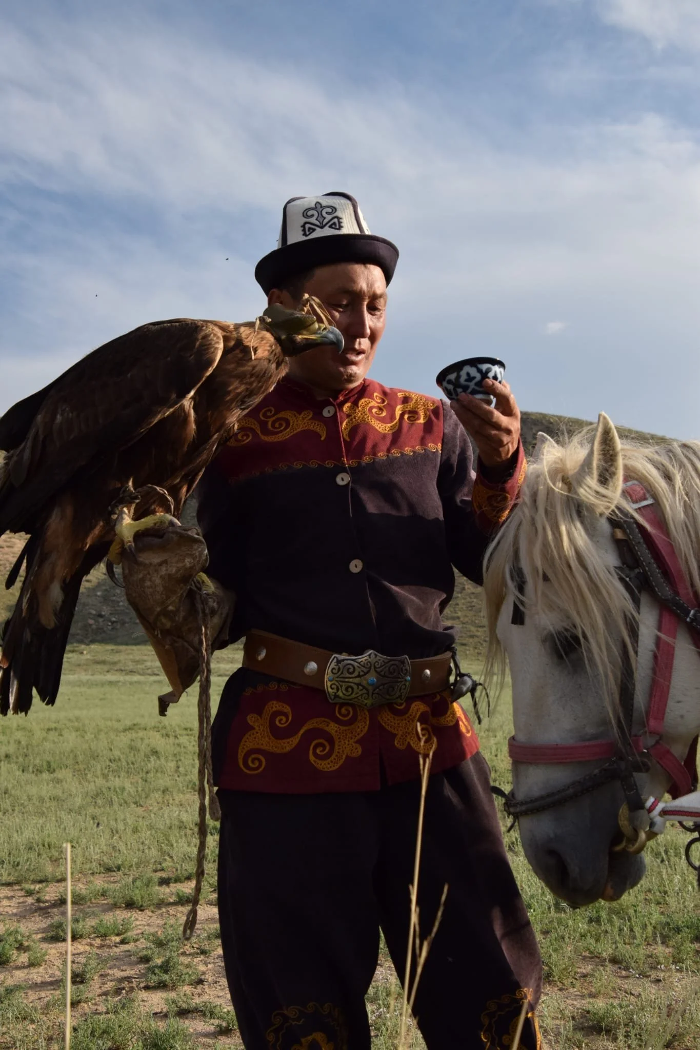 Eagle Hunter in Kyrgyzstan holding traditional piala, Piala Trails