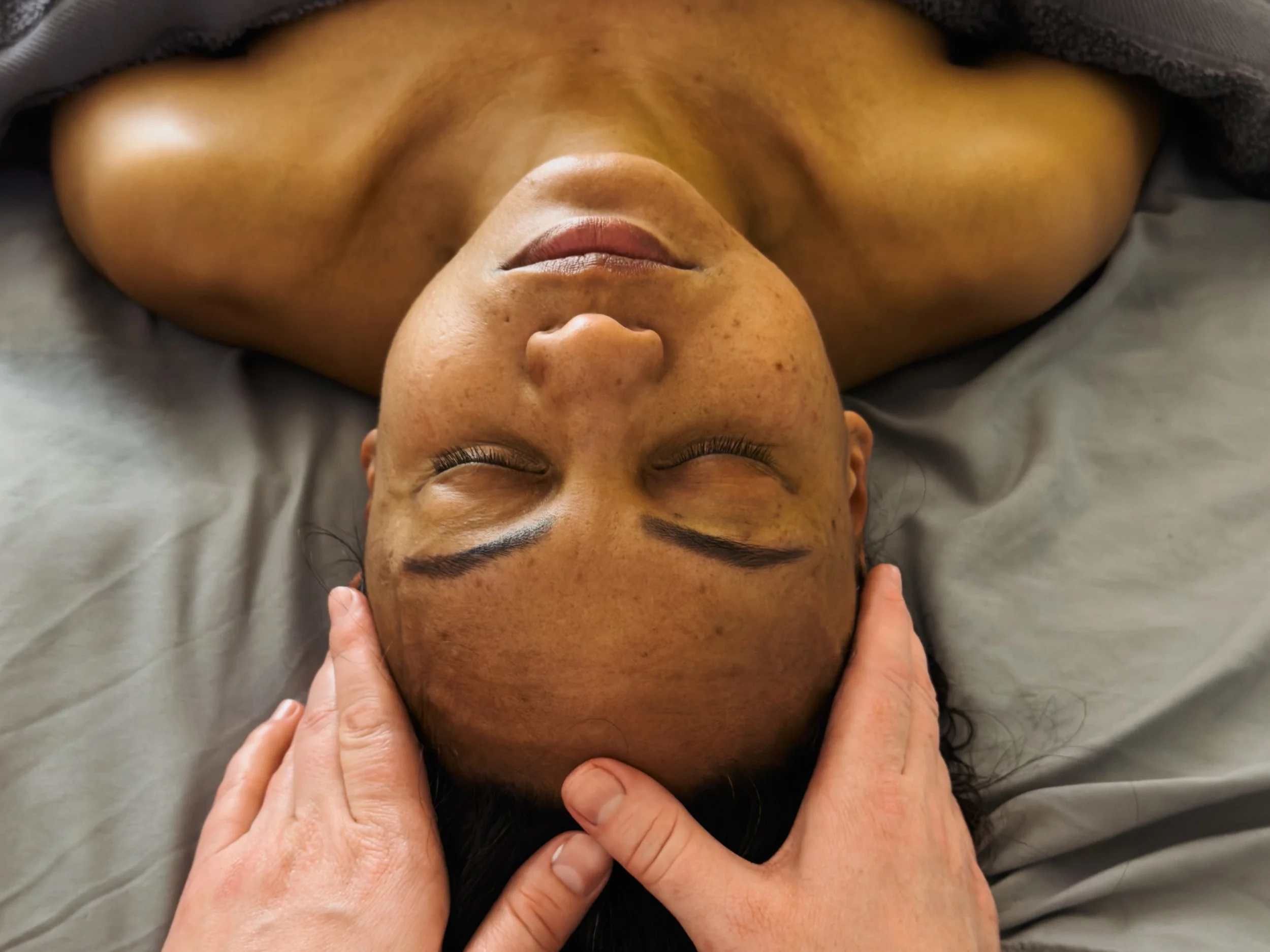 Person receiving a relaxing facial and neck massage treatment at inSoul Wellness in Greenwich, supporting relaxation, stress relief and overall wellbeing.