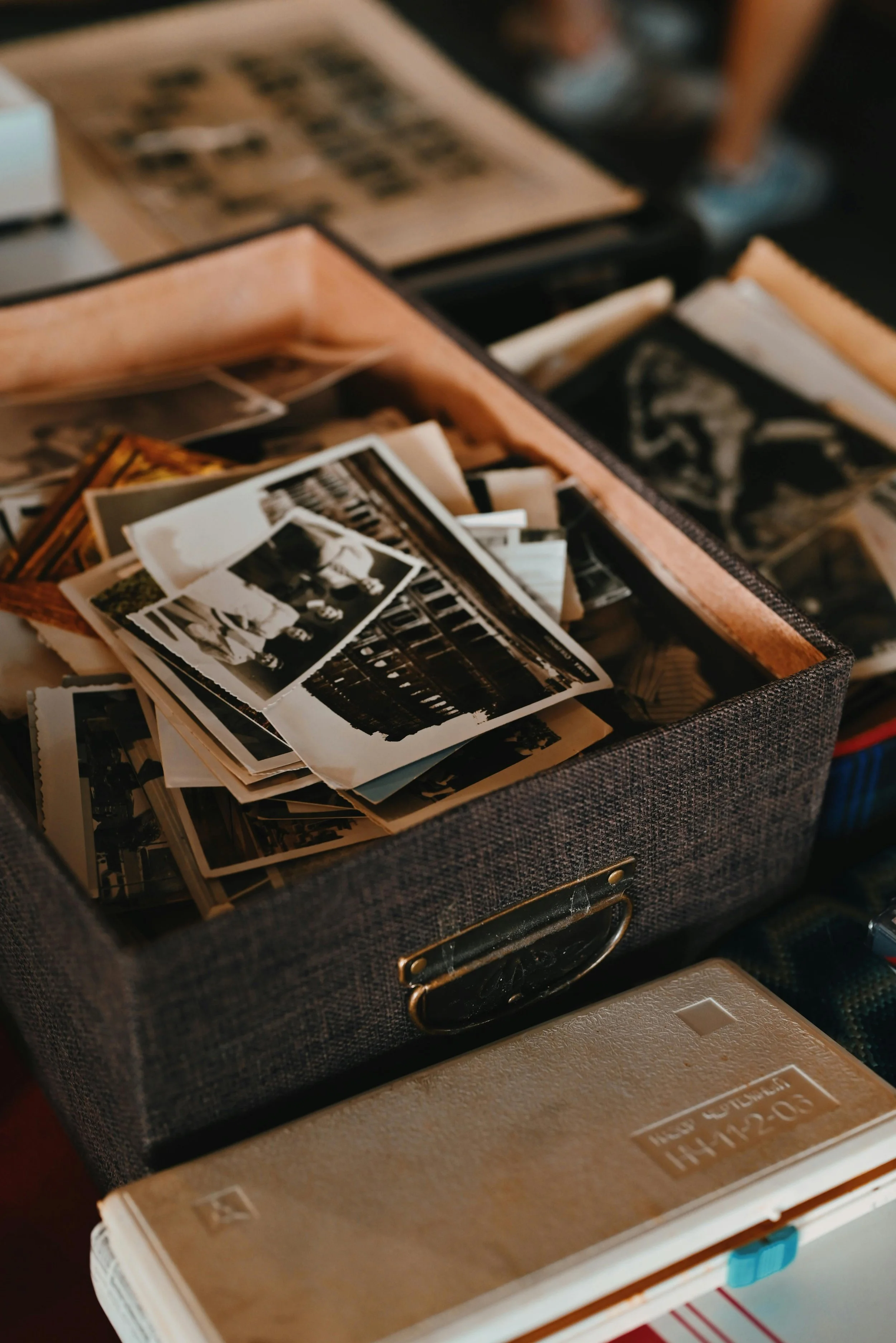 A box filled with old black and white photographs.