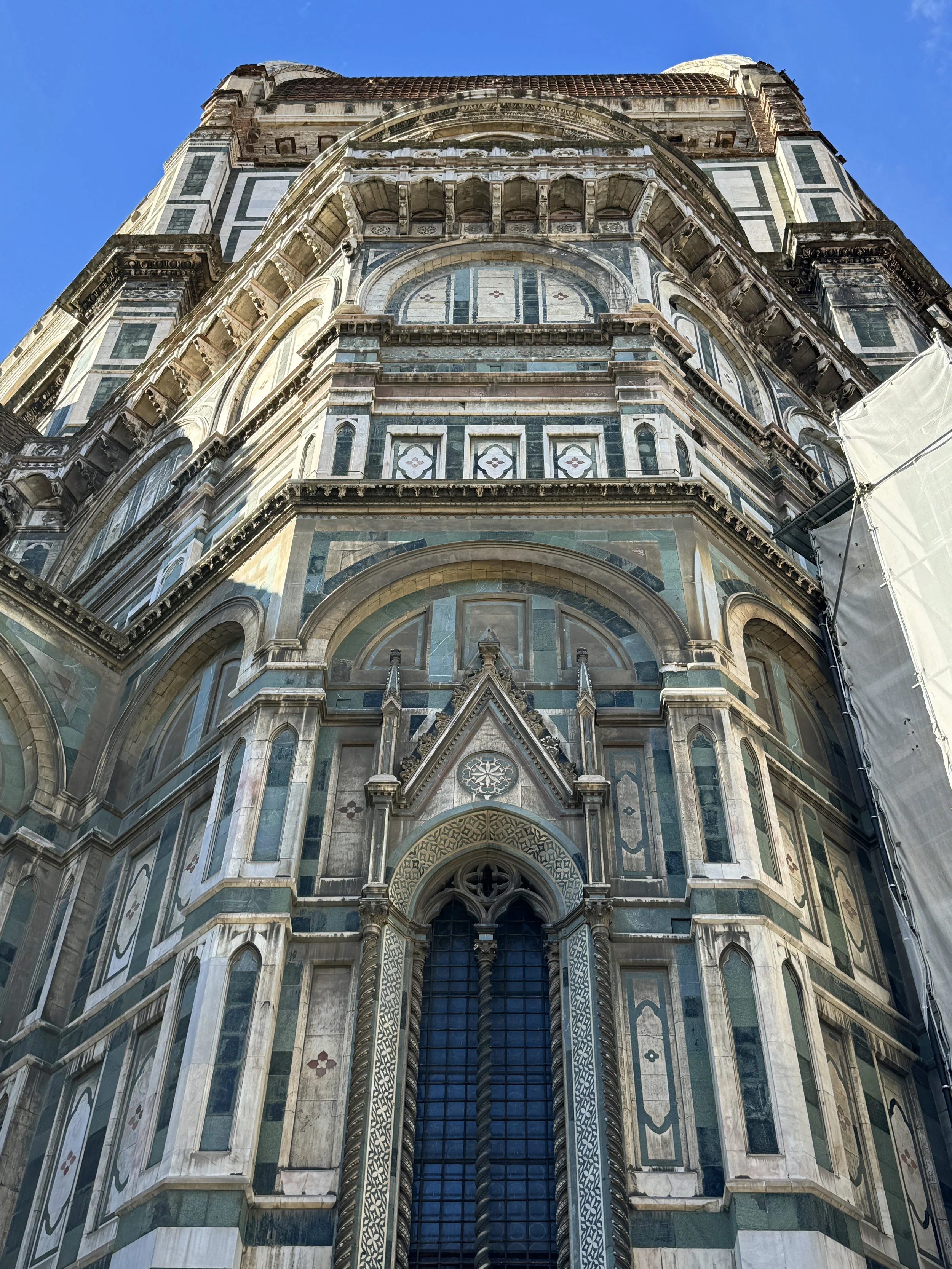 The underside of the dome of the Florence Cathedral, showing intricate marble work and architectural details.