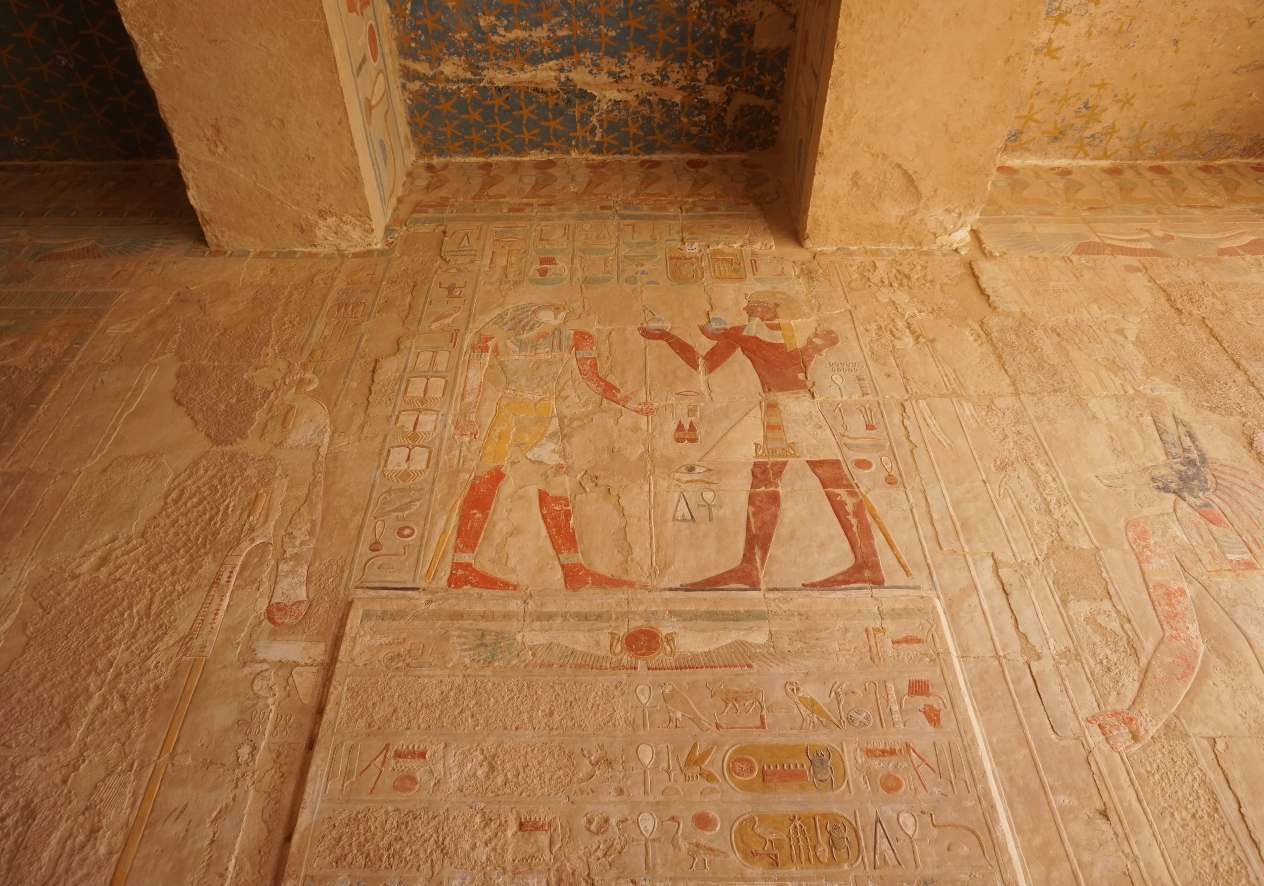 Ancient Egyptian wall carvings and hieroglyphics.