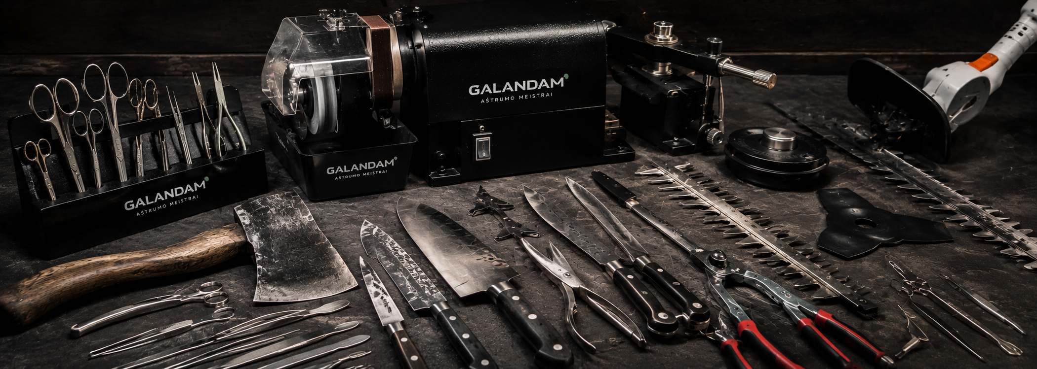 An array of professional kitchen knives, scissors, and sharp tools arranged on a dark surface, with a knife sharpening motor and various sharpening tools.