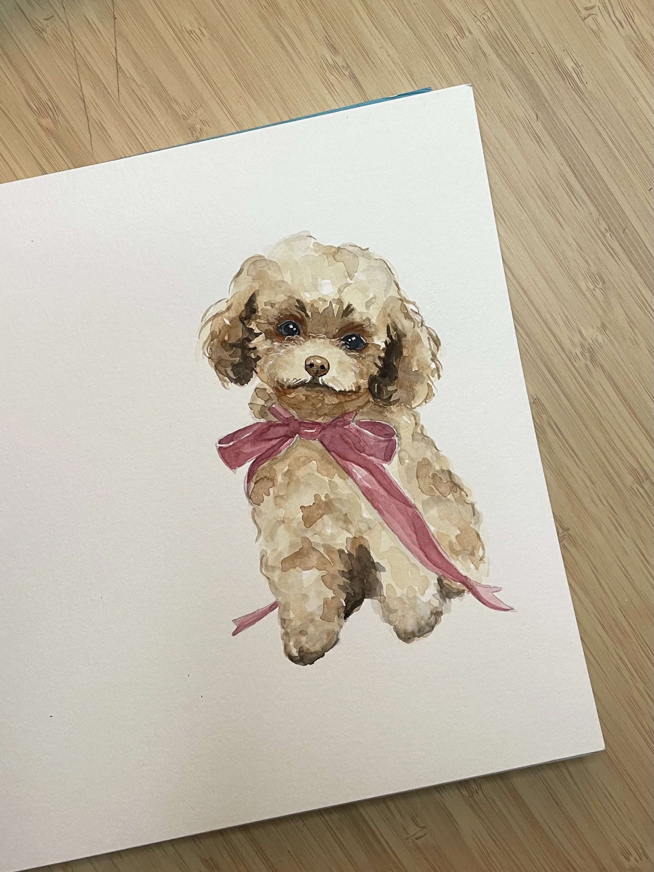 Une peinture d'un petit chien poodle beige avec un ruban rose autour du cou, debout sur fond blanc.