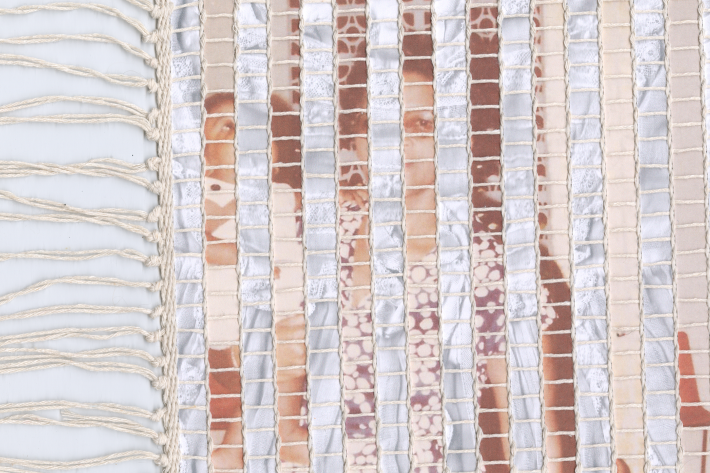 Mixed media weaving created using strips of family photographs.