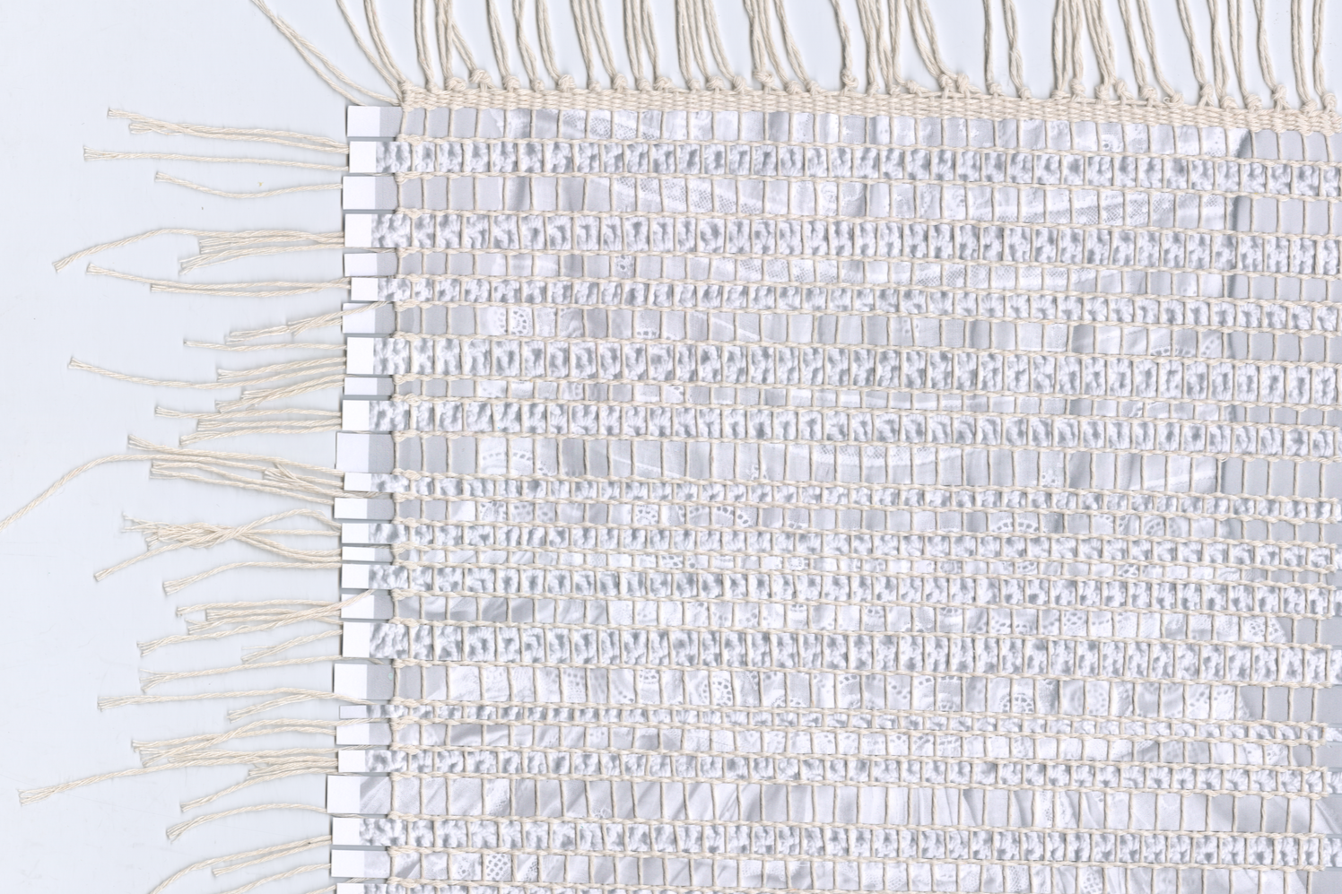 Mixed media weaving created using strips of family photographs.