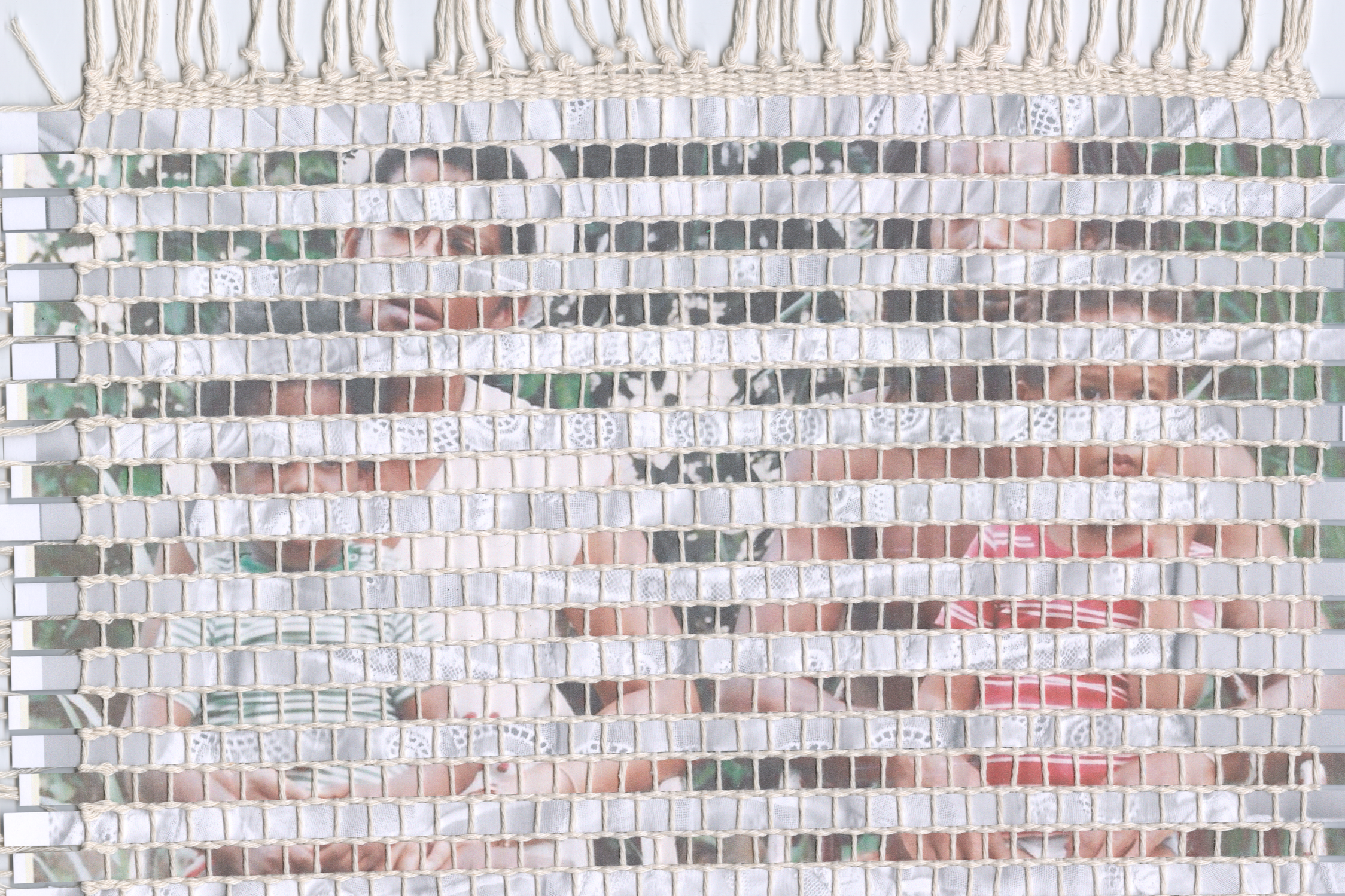 Mixed media weaving created using strips of family photographs.