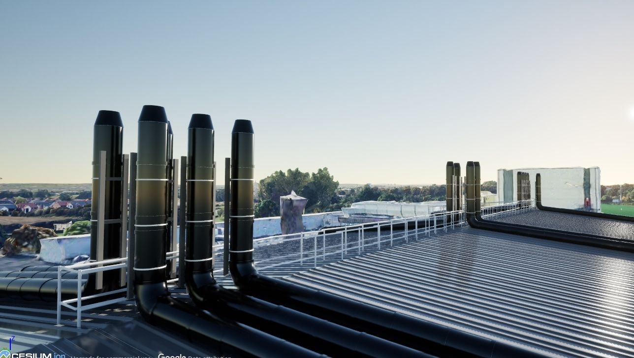 Rooftop industrial ventilation system with exhaust pipes and blue sky.