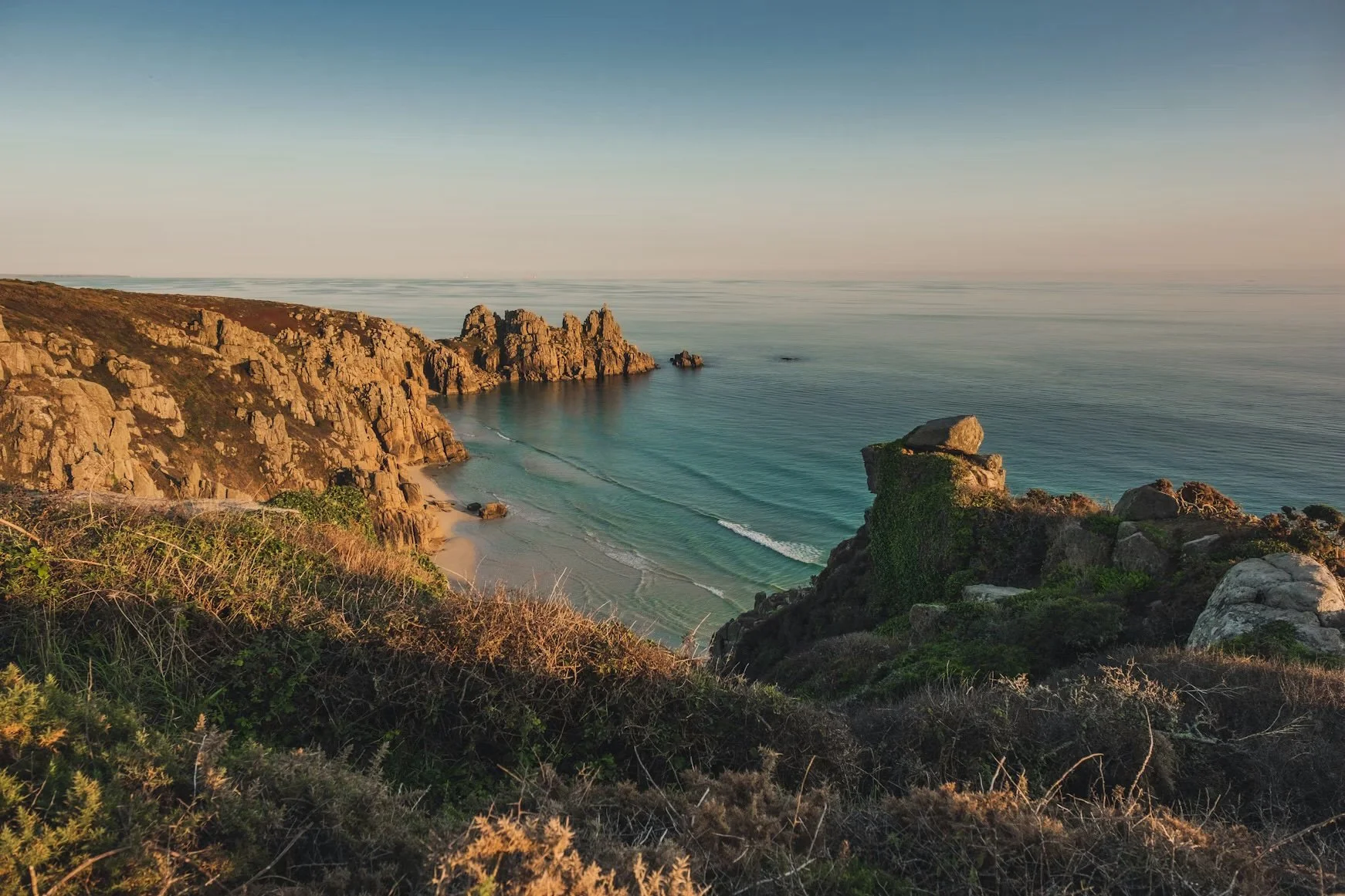 Cornish coastline alongside a portrait of Jo, founder and therapist at Sawya Mind and Body