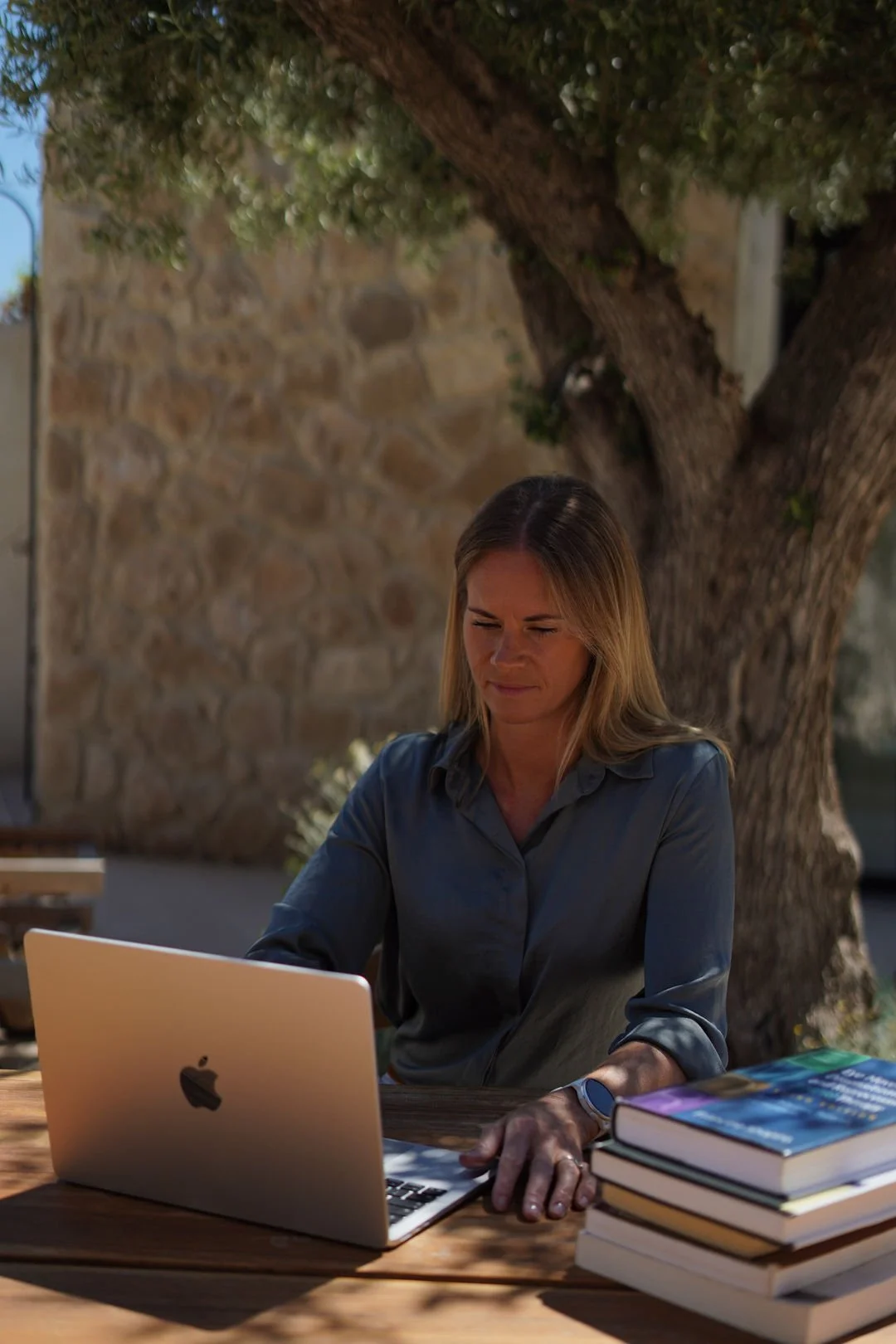 Jo working on a laptop outdoors