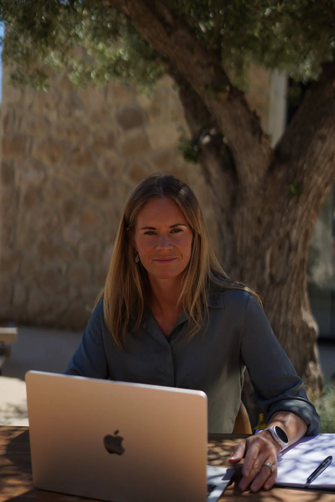 Jo working on a laptop outdoors