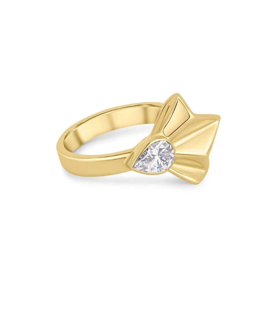 Gold ring with a heart-shaped diamond and additional gold accents.