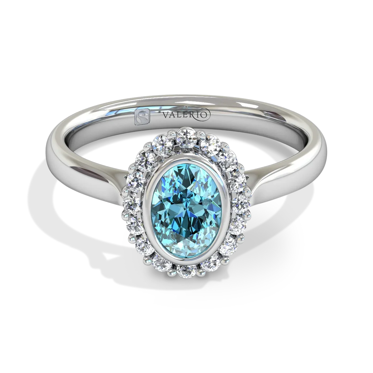 Silver ring with an oval blue gemstone surrounded by small clear diamonds.