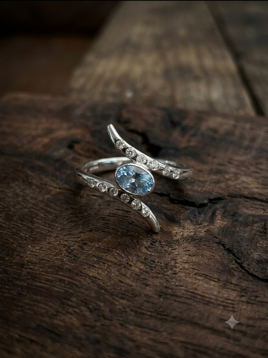 A person is holding a jewelry box containing a gold bracelet with a blue gemstone, in a workshop or jewelry store setting.