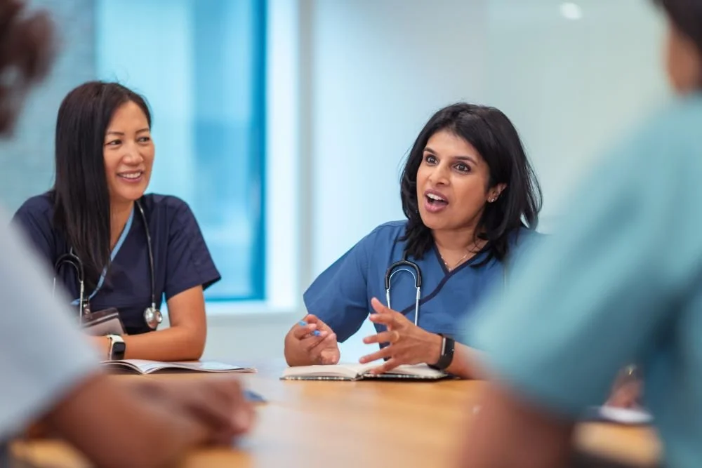 doctors discussing remote patient monitoring patient using CareMonitor virtual care solution