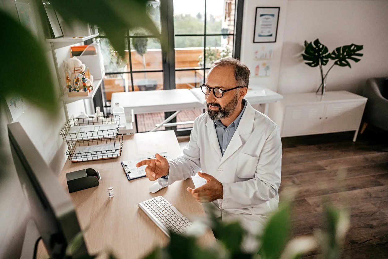 clinician healthcare provider giving telehealth consultation using CareMonitor digital healthcare platform