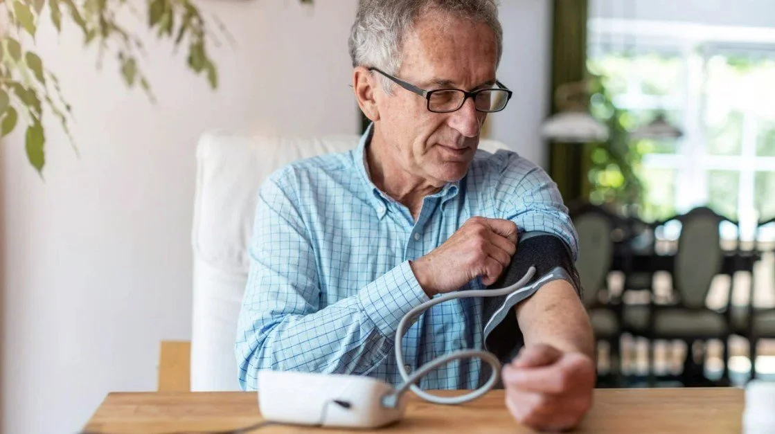 man taking blood pressure using caremonitor chronic disease management platform