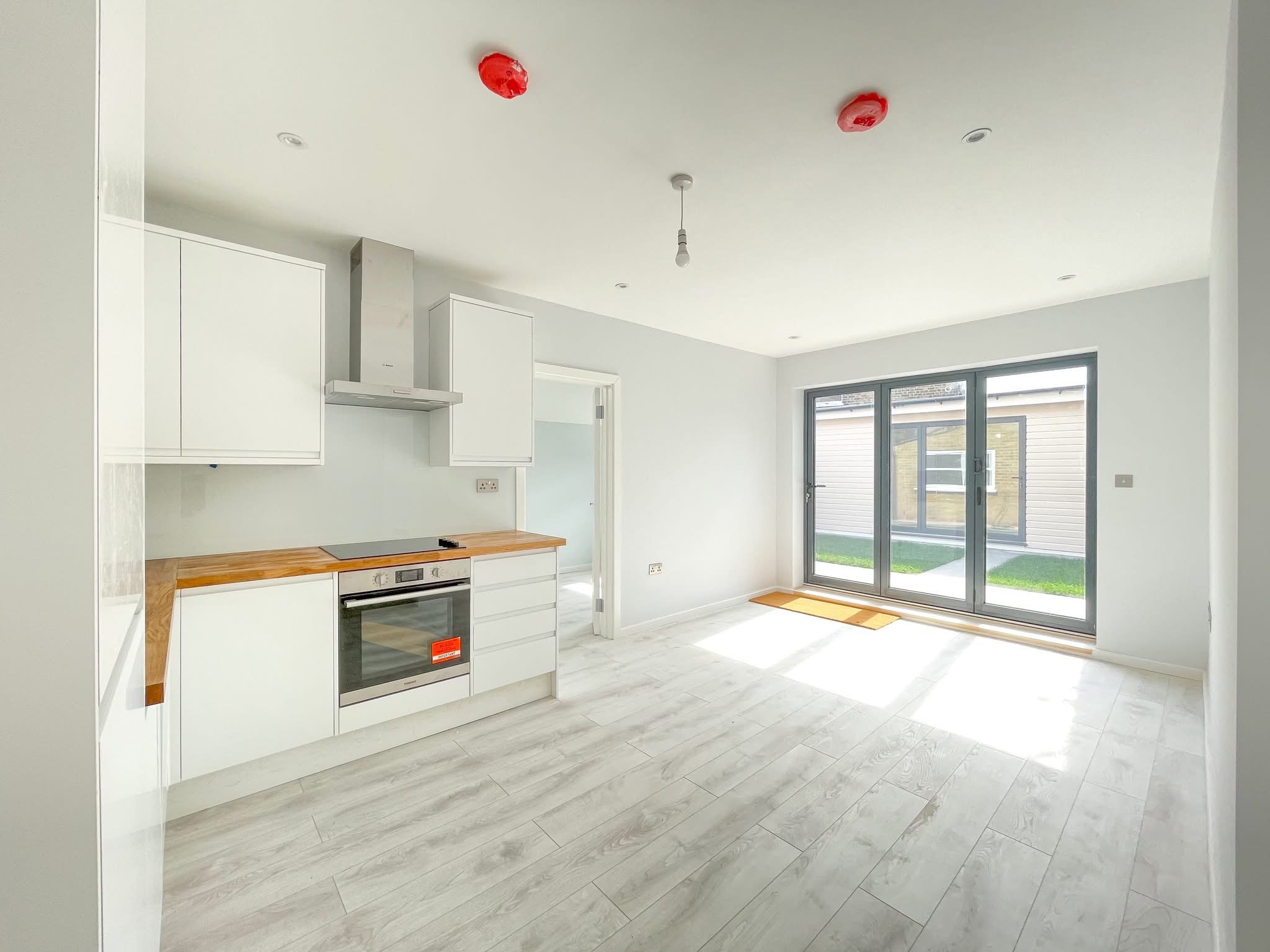 Bright refurbished kitchen and living space with garden access.