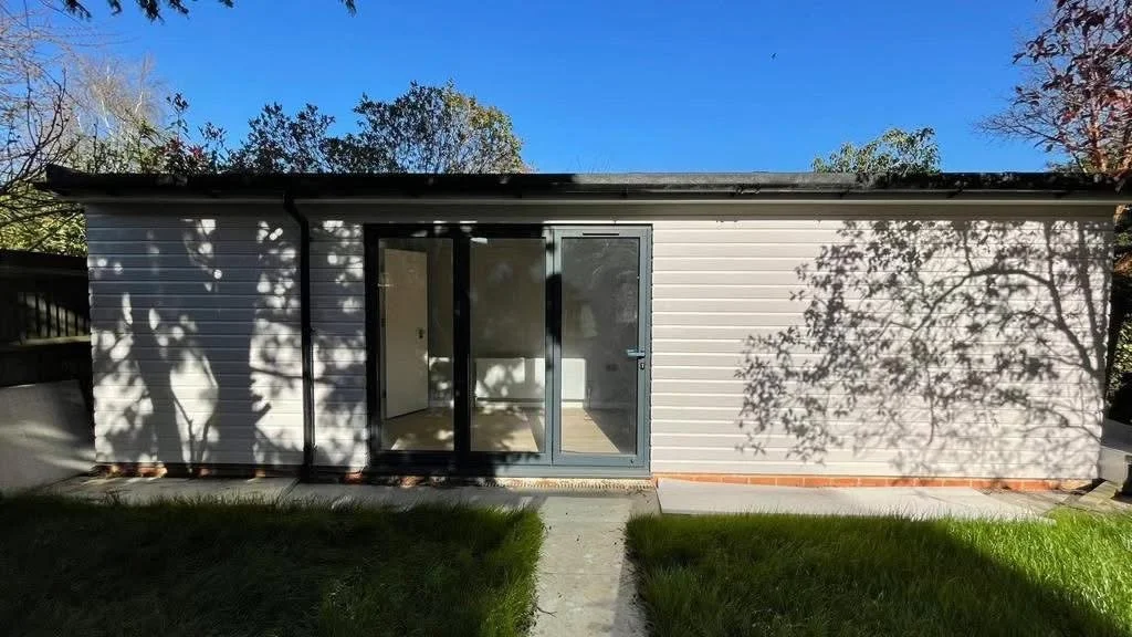 Completed garden room / outbuilding with modern doors and external finish.