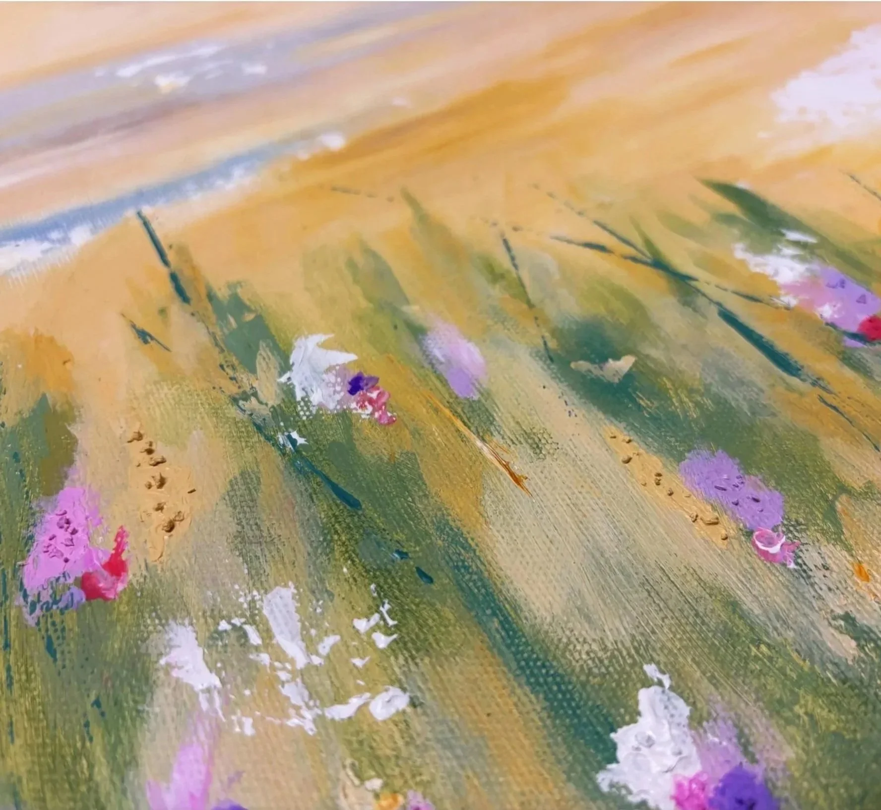 Close-up view of an abstract painting with yellow, green, white, pink, purple, and blue colors, featuring textured brushstrokes and floral-like patterns.
